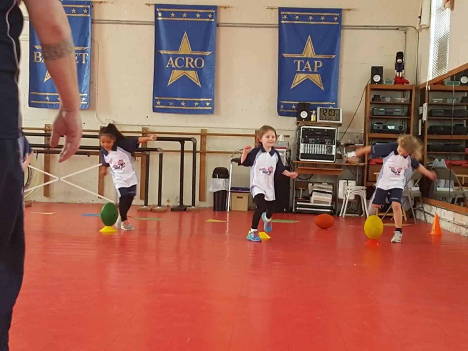 a group of kids playing with balls