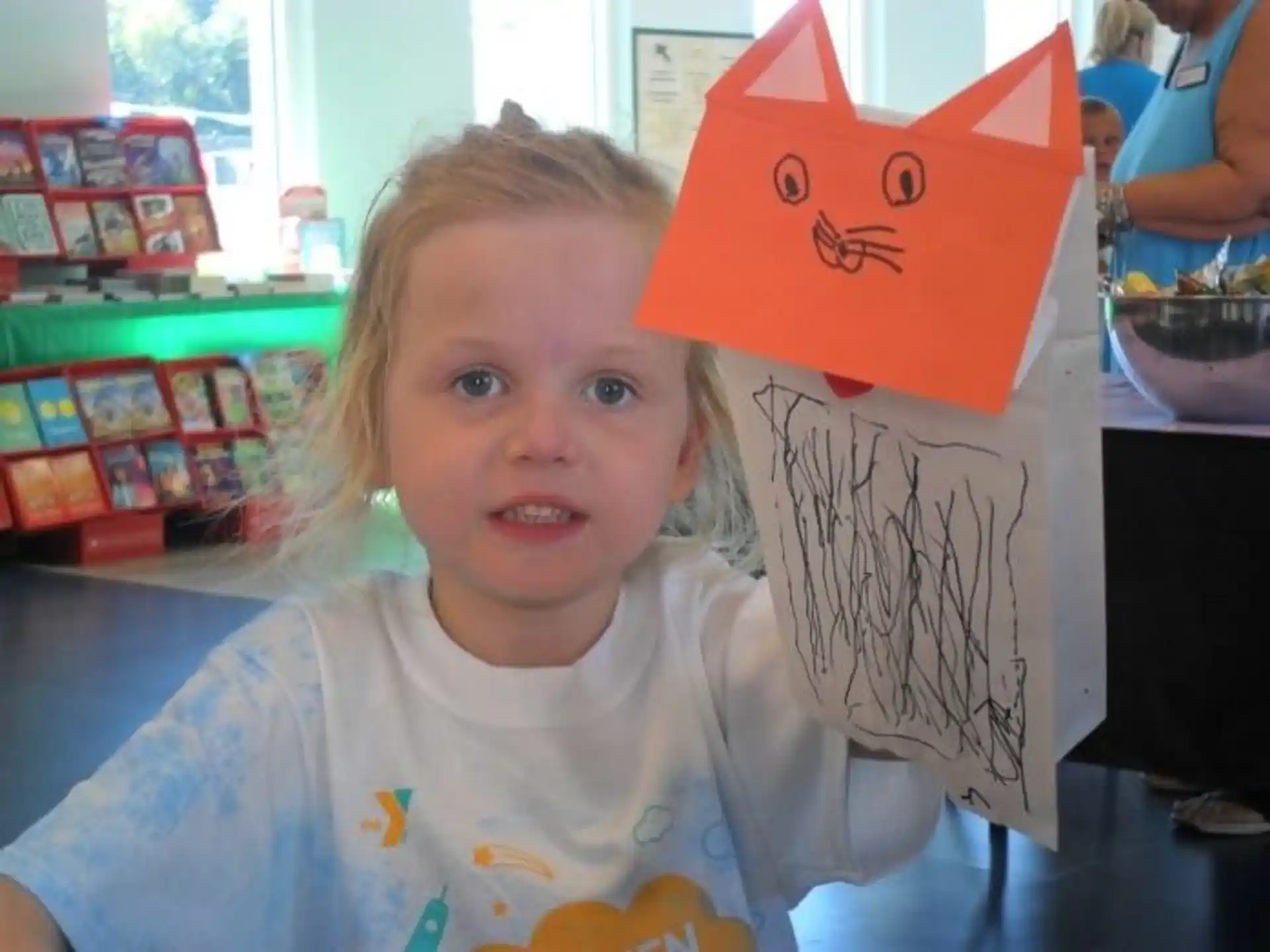 a child wearing a paper hat