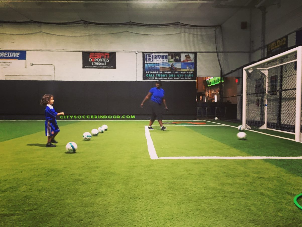 a person and a child playing football