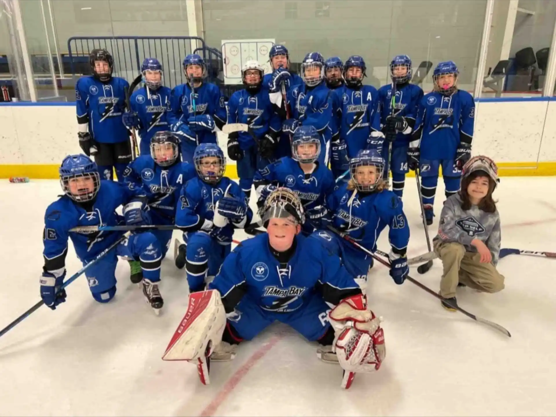 a group of hockey players posing for a photo