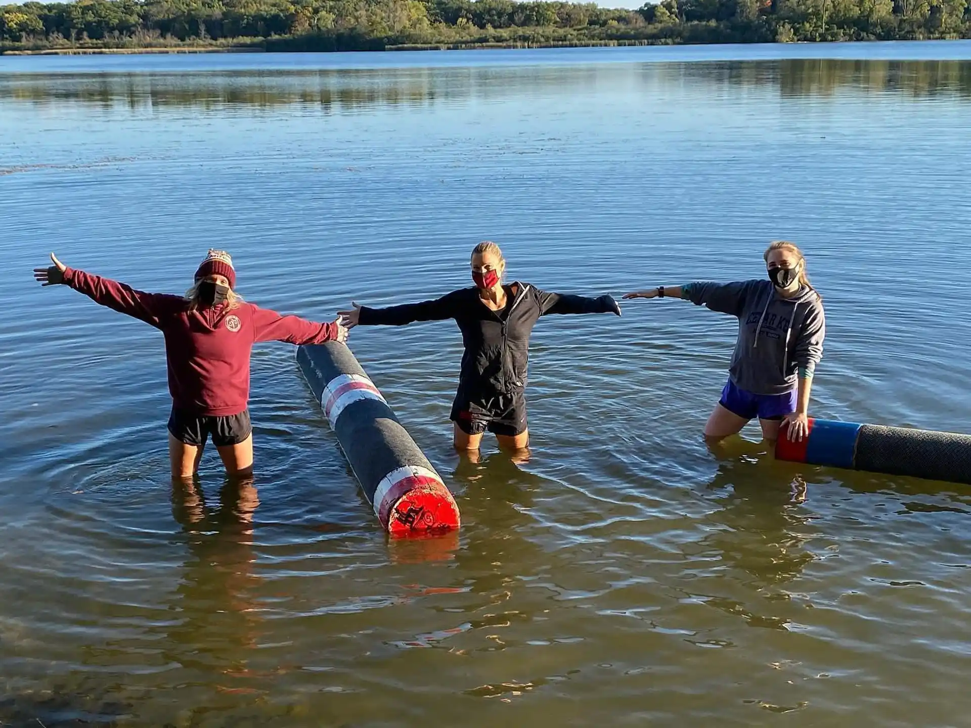 a group of people in a body of water posing for the camera