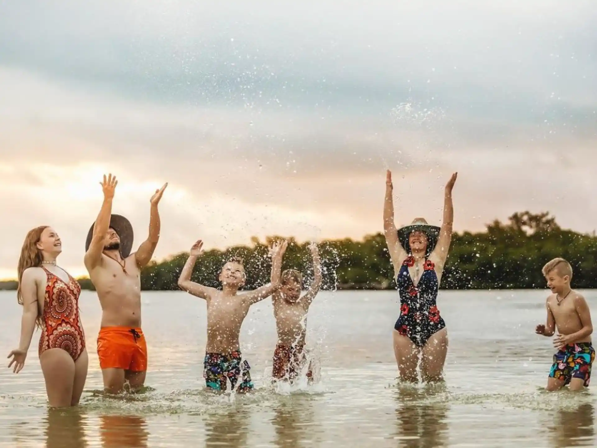 a group of children jumping into water