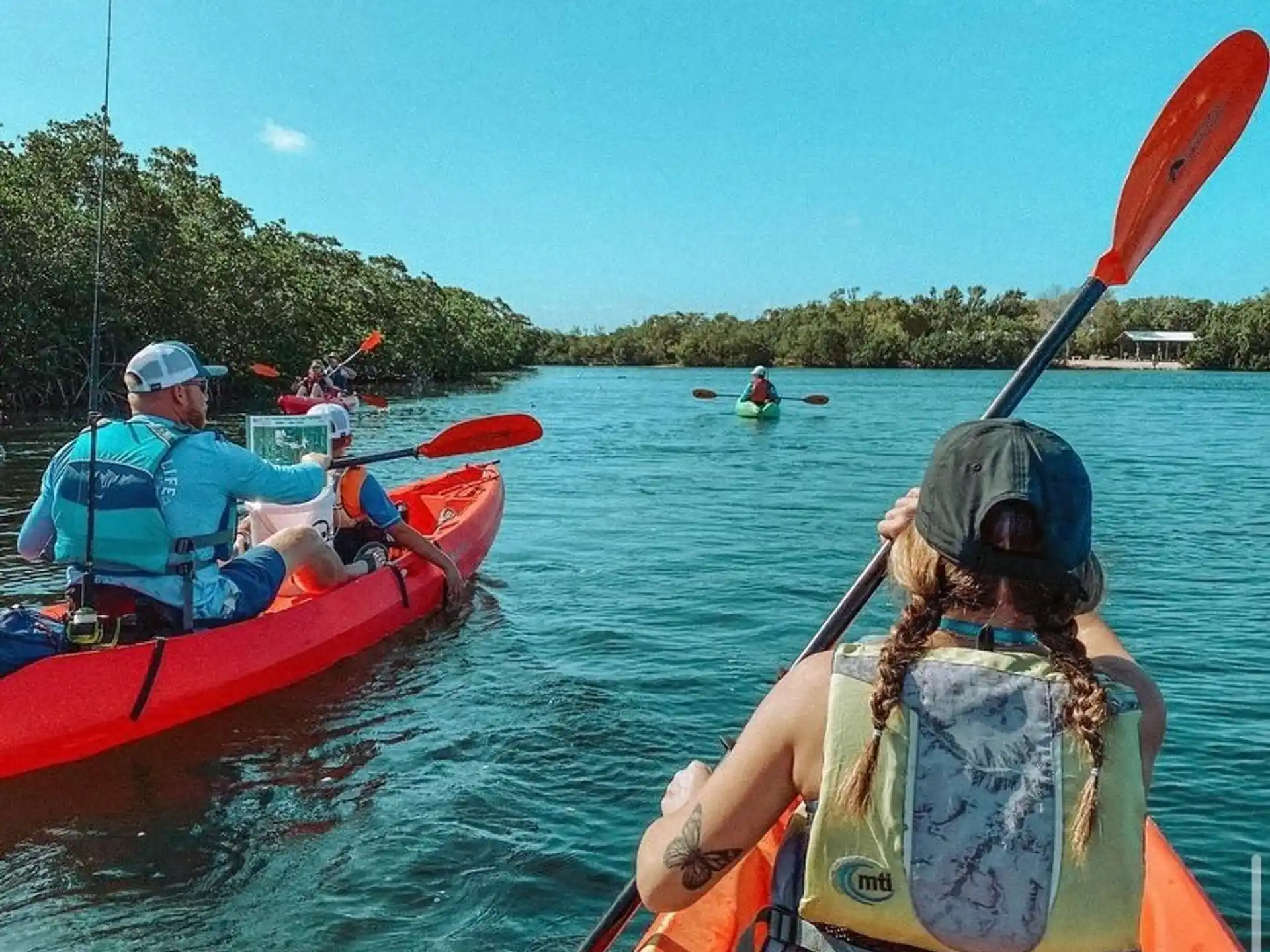 people in kayaks on a river