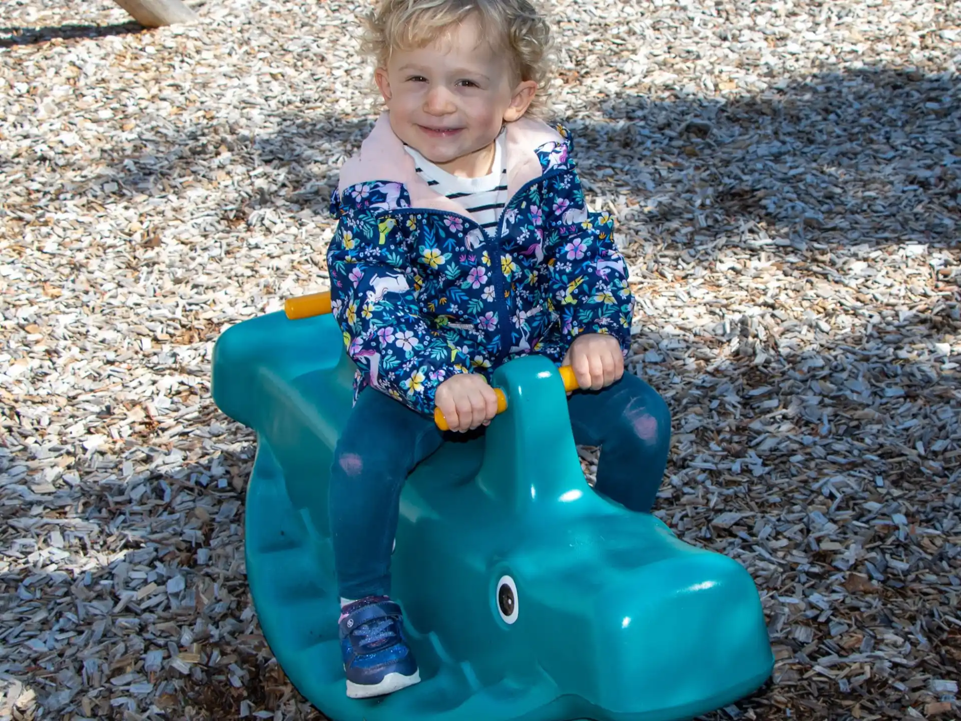 a child sitting on a toy