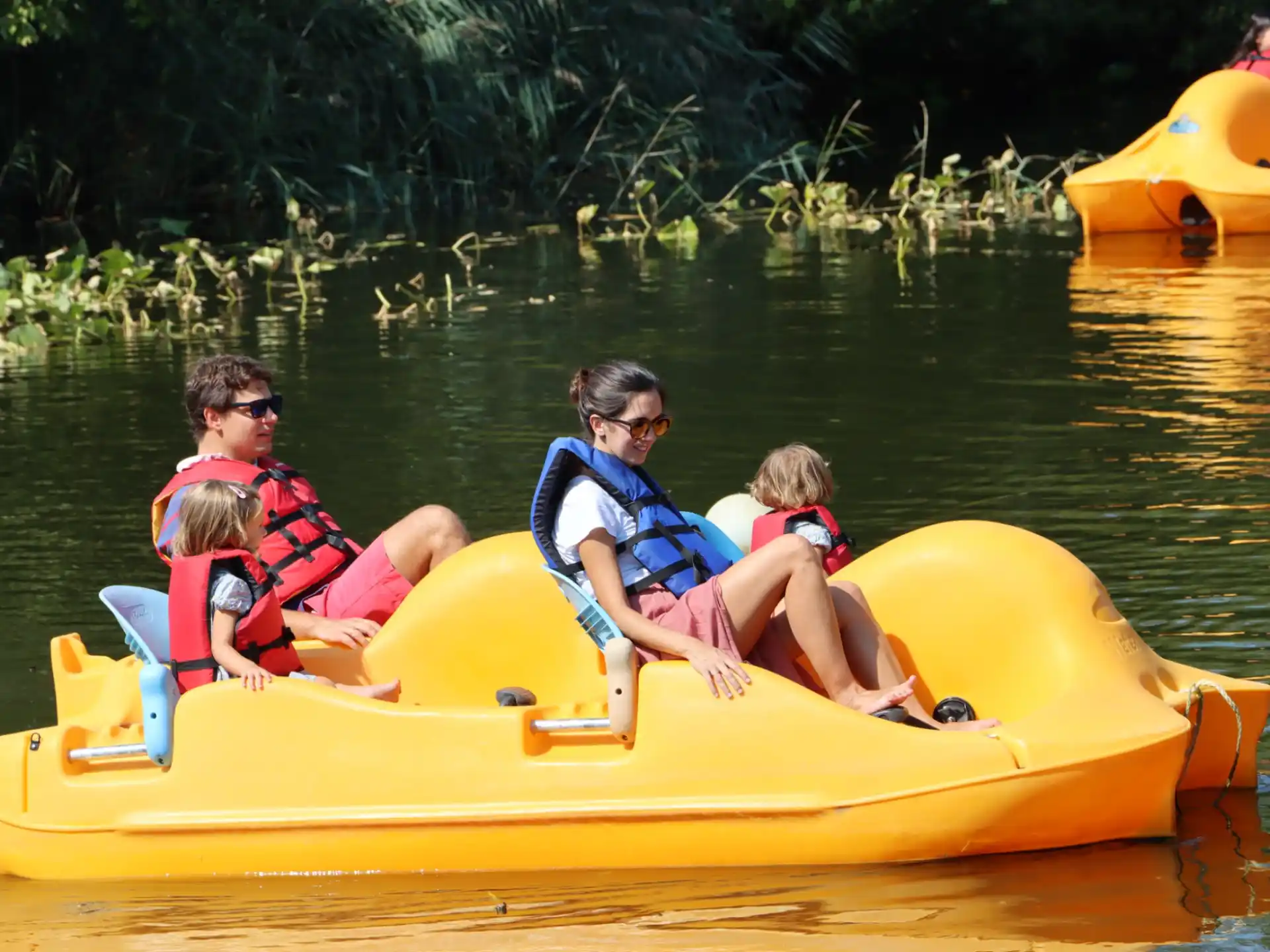 a group of people in a yellow boat on water