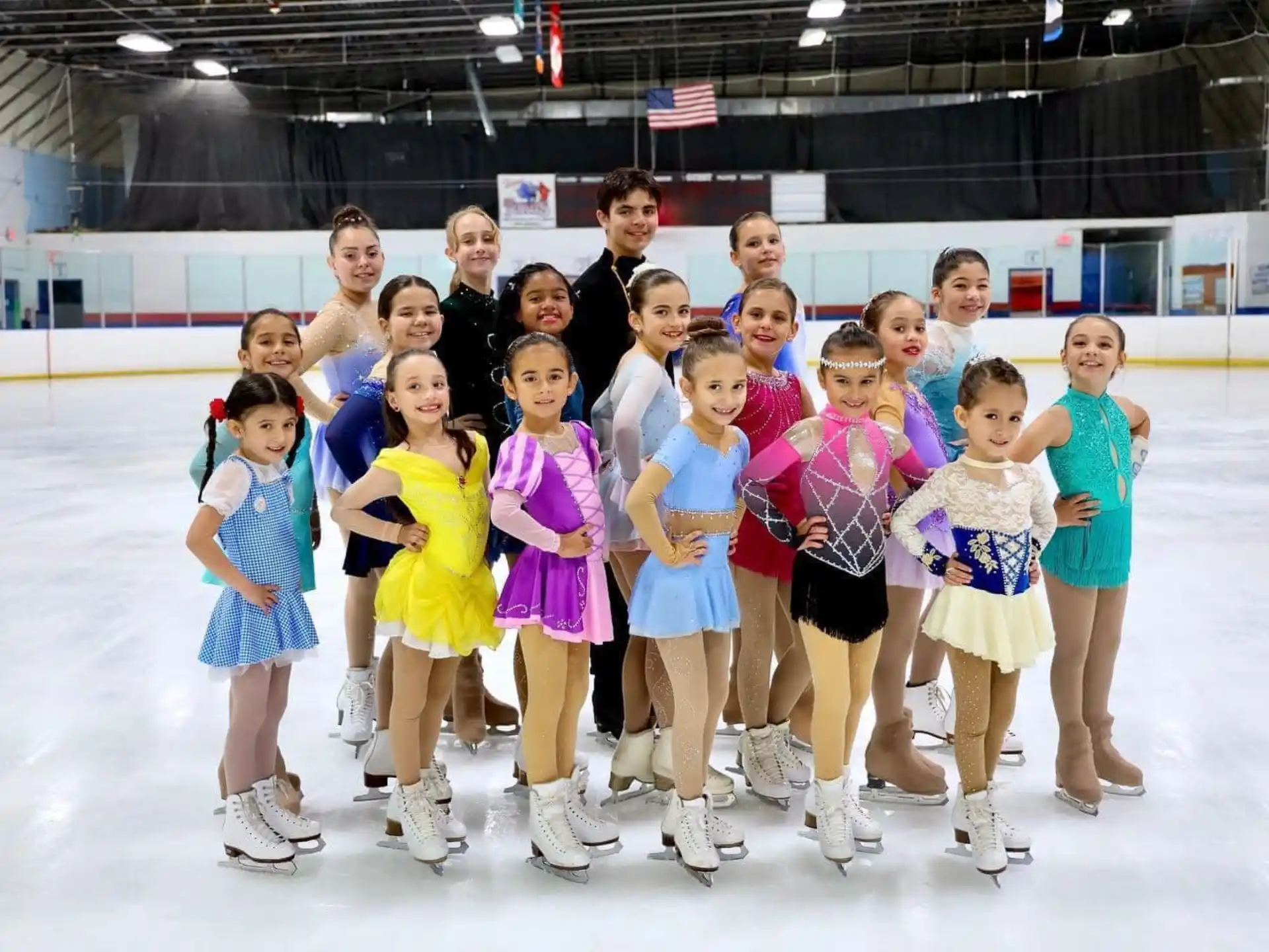 a group of people wearing ice skates posing for a photo