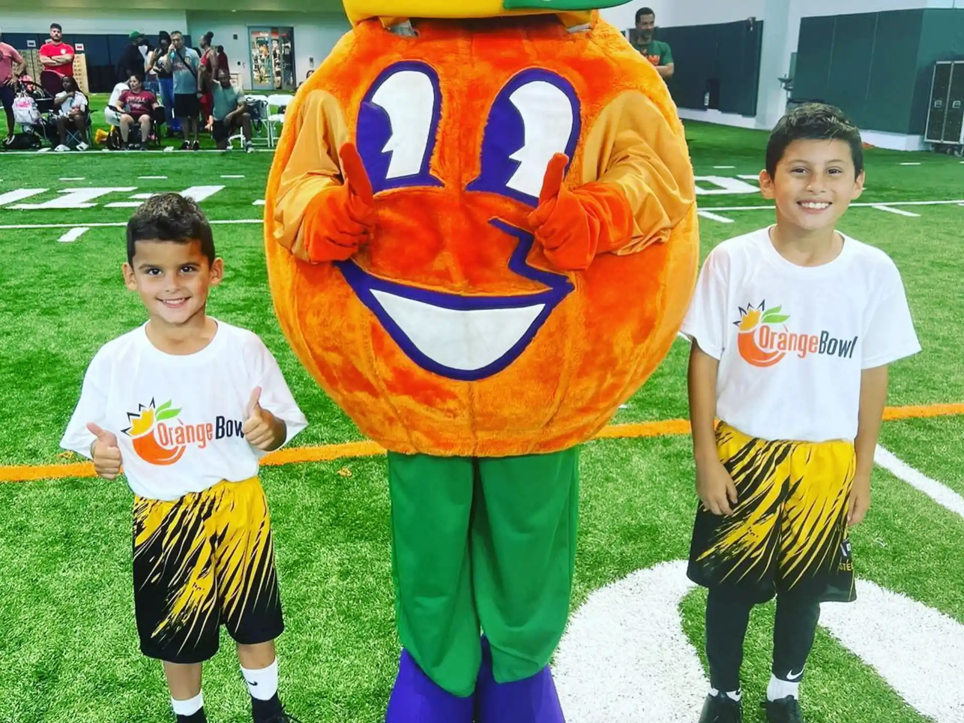 a couple of boys posing for a picture with a flag