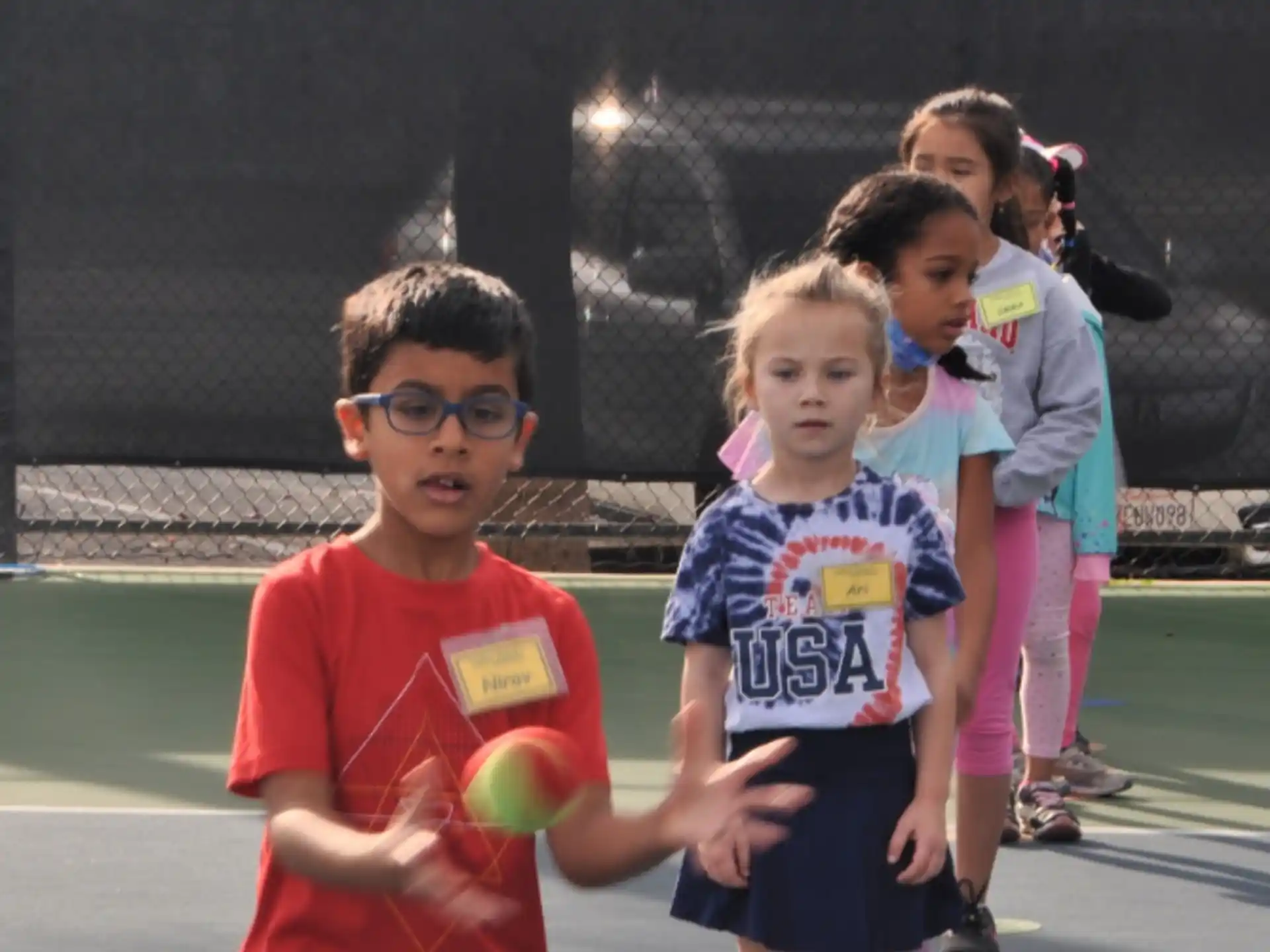 a group of children playing basketball