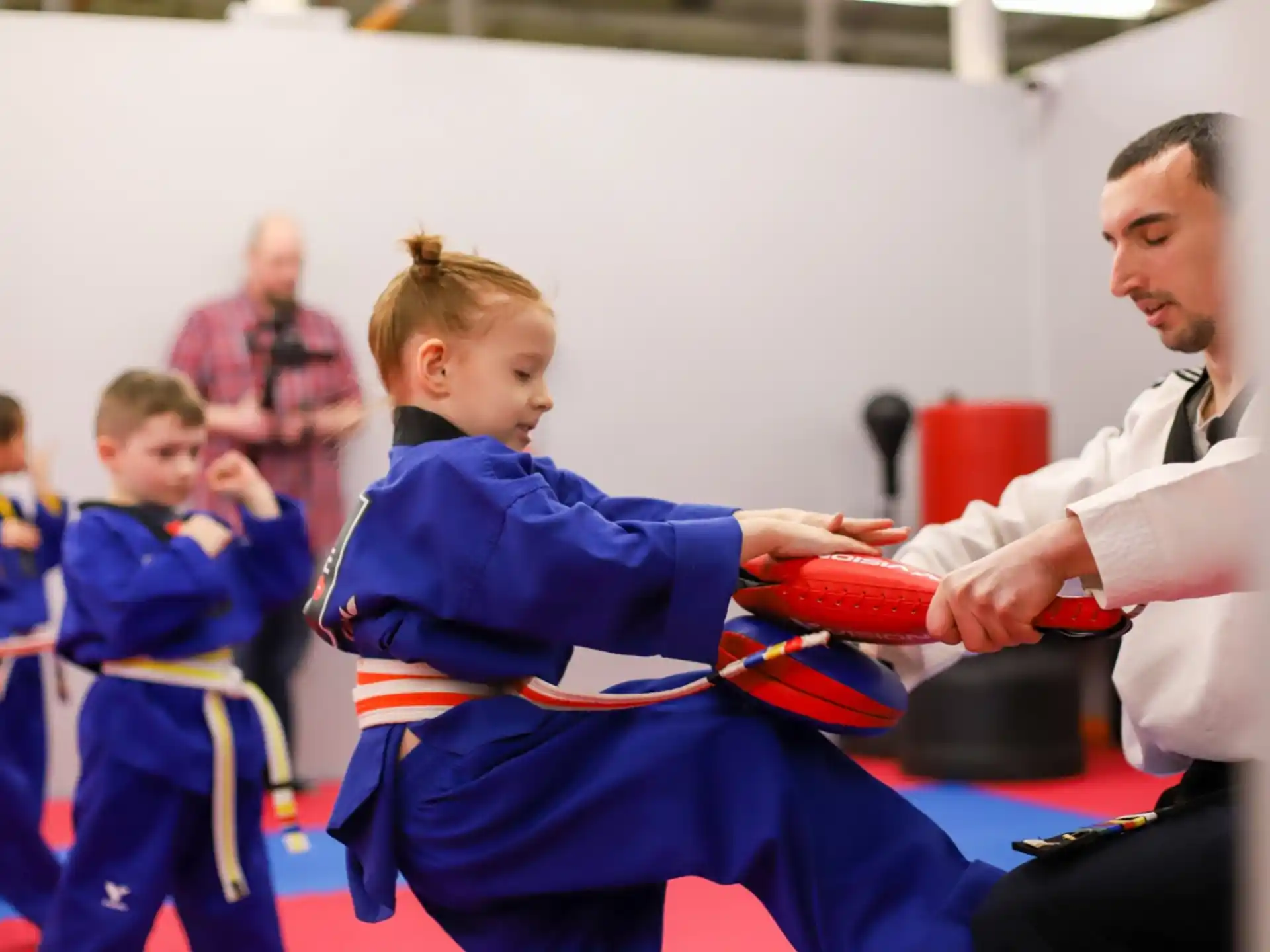 a person and a boy in karate uniforms