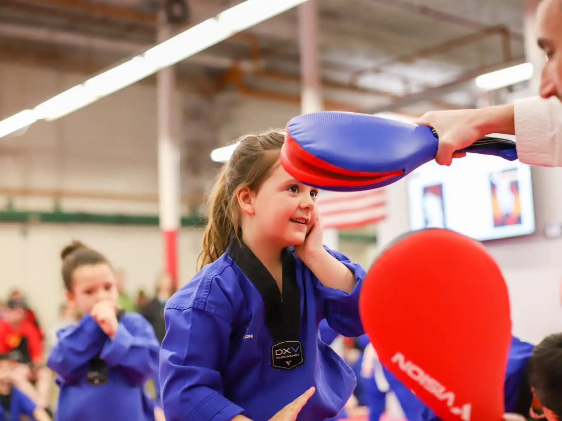 a person in a blue uniform holding a balloon