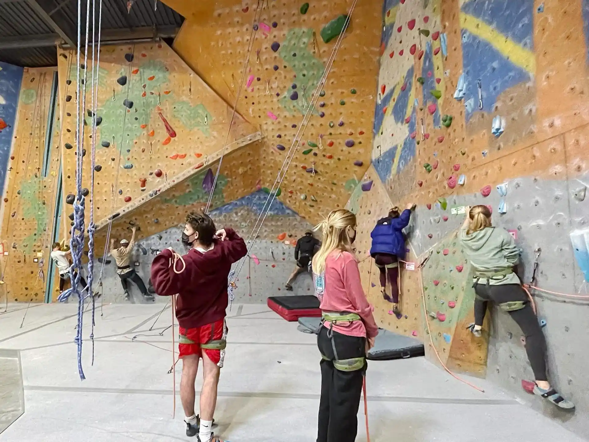 a group of people on ice skates in a room with graffiti