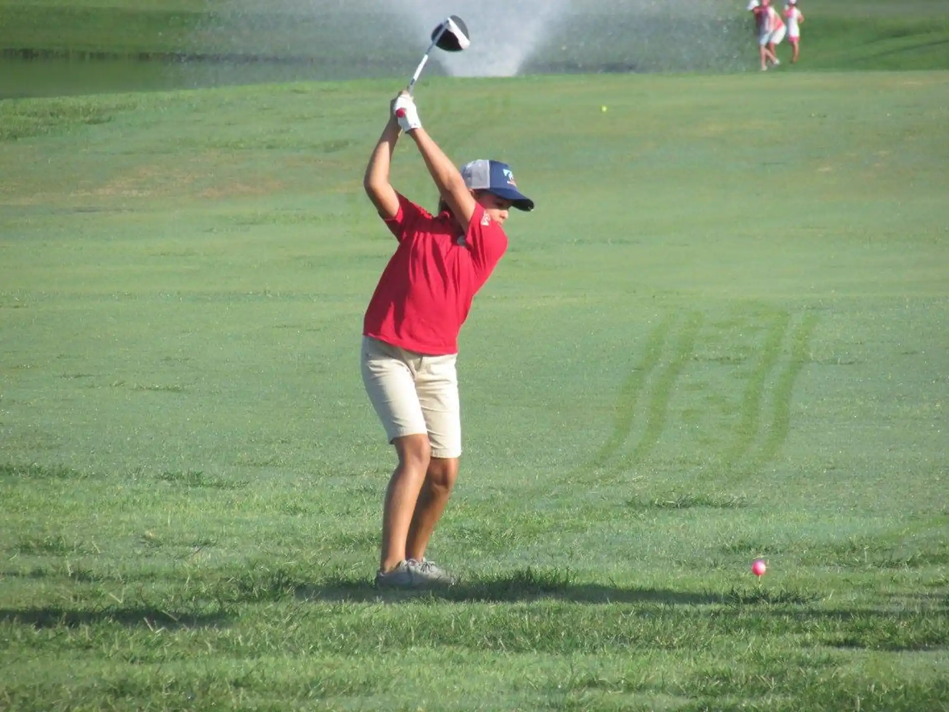 a person swinging a golf club