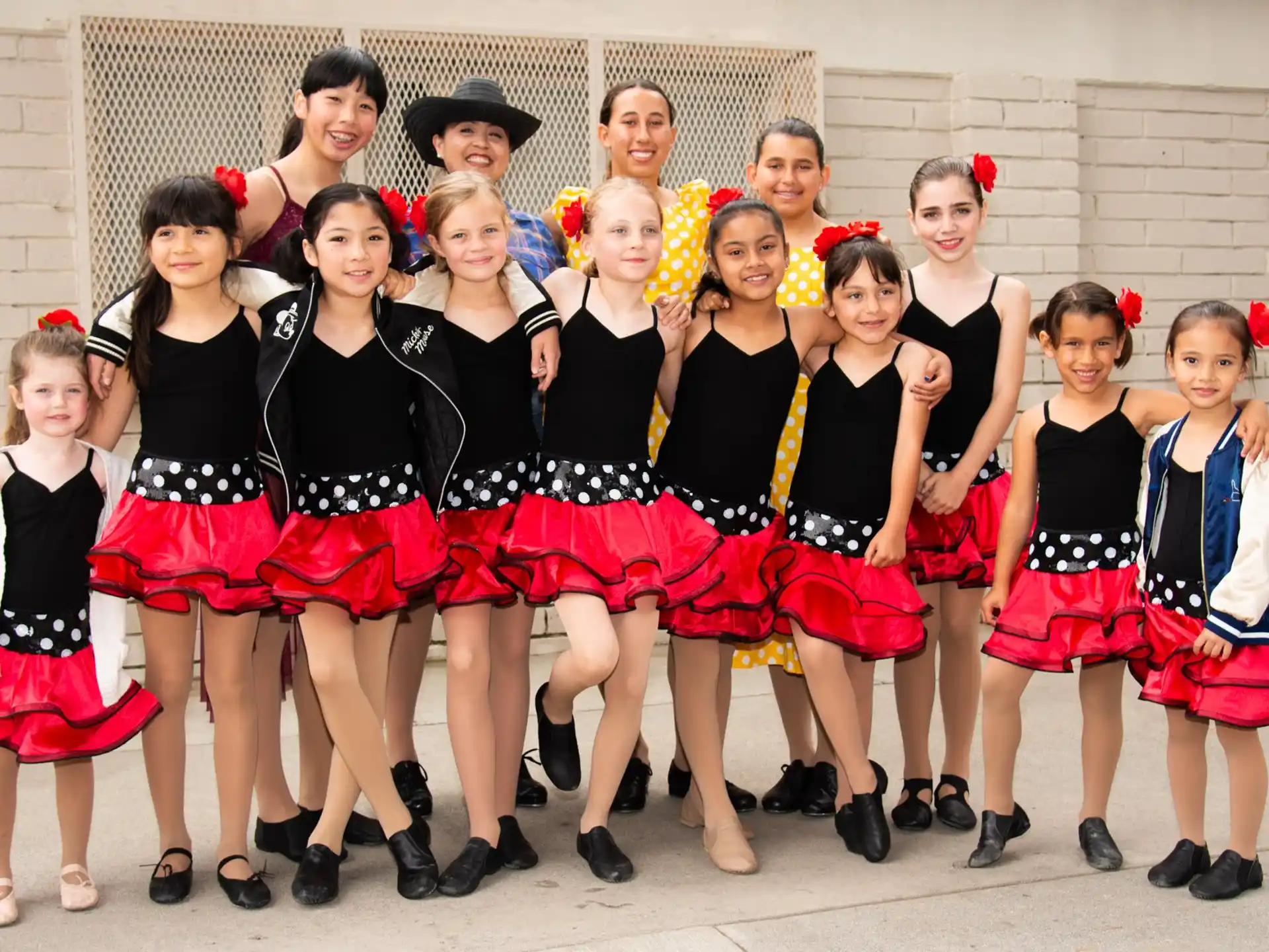 a group of girls in matching outfits