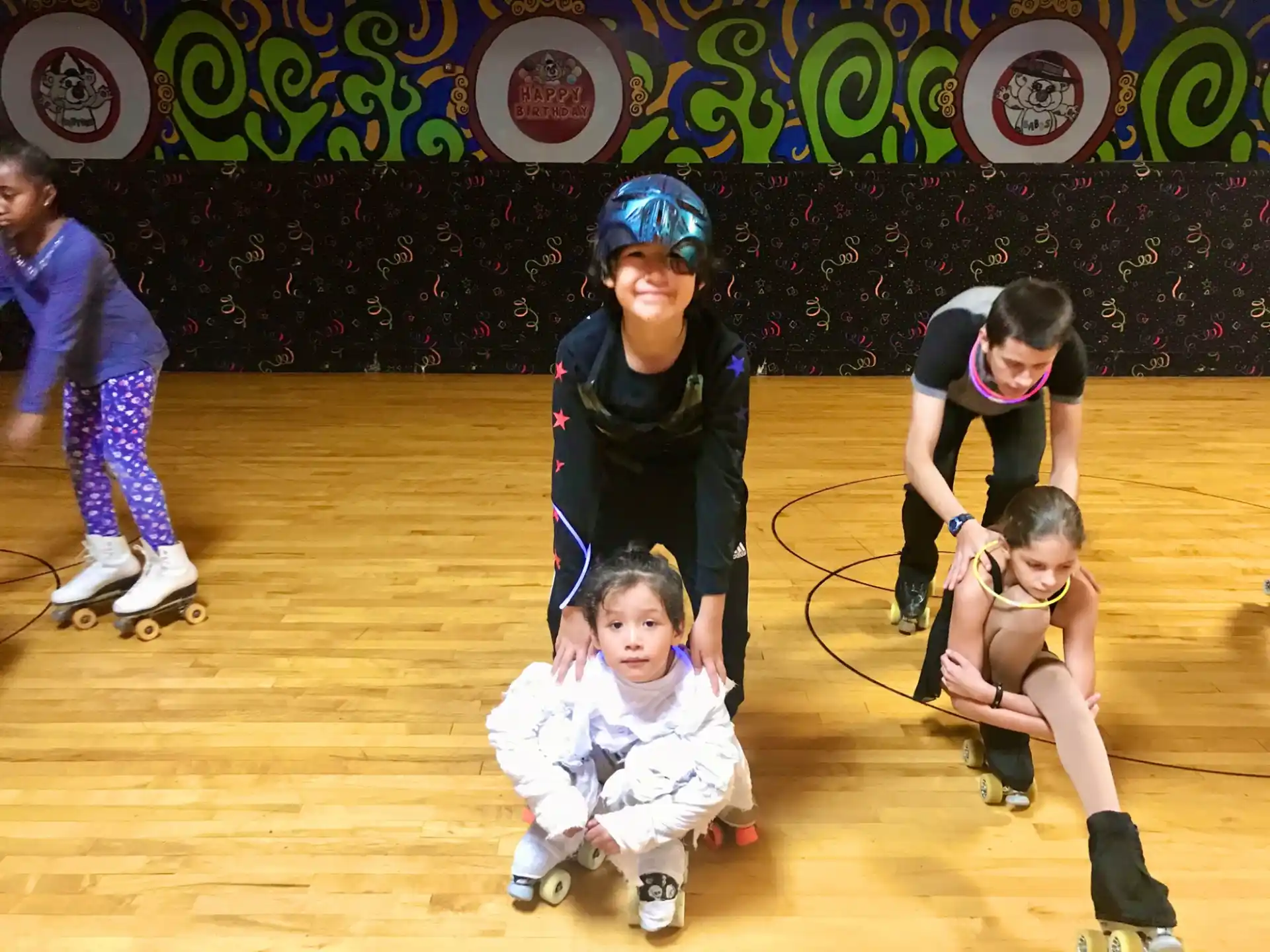 a group of kids wearing roller blades
