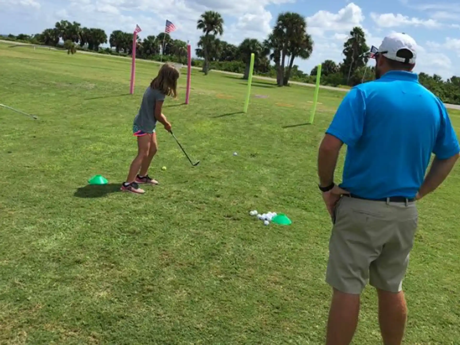 a person and a girl playing golf