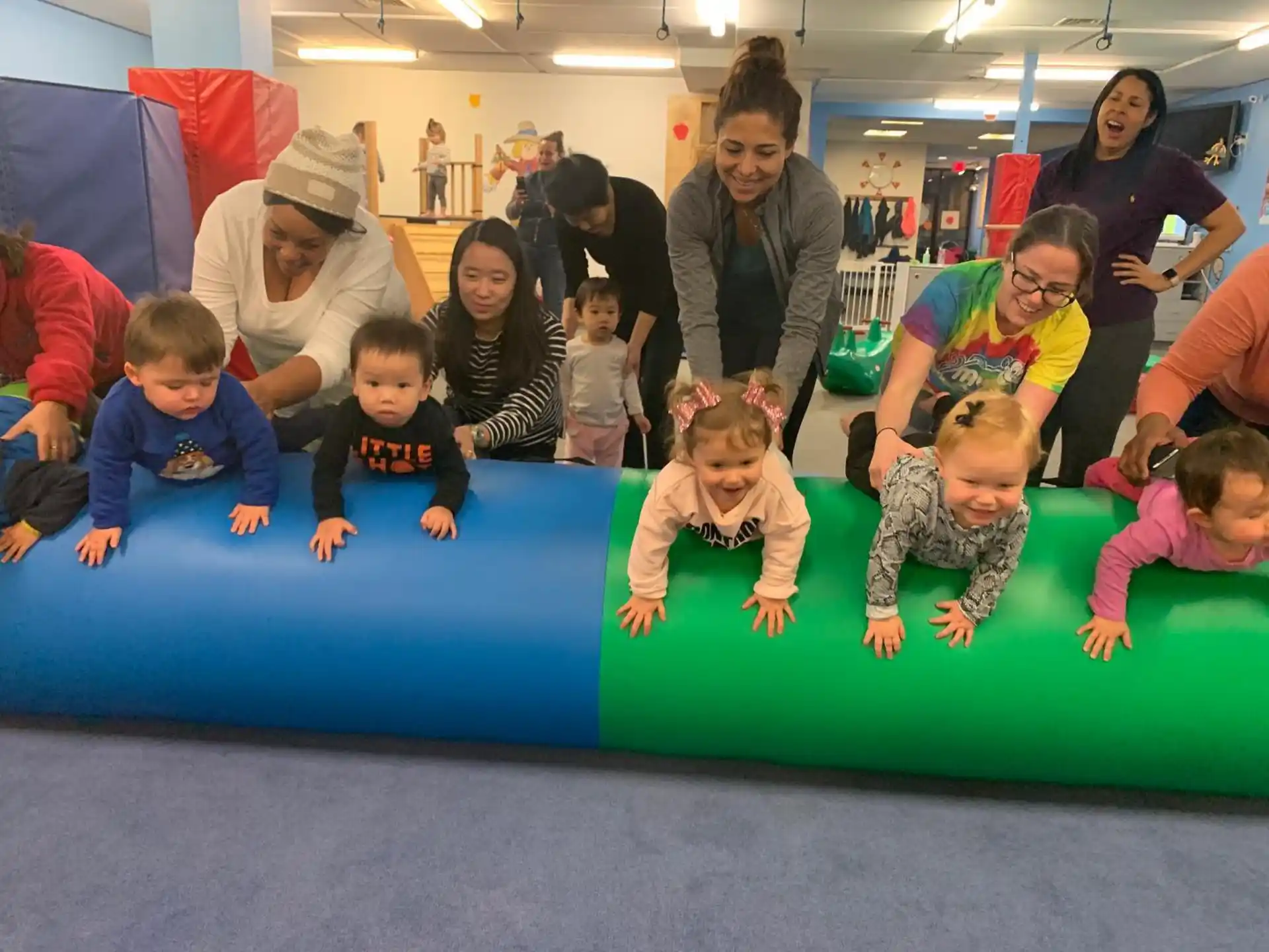 a group of children sitting on a mat