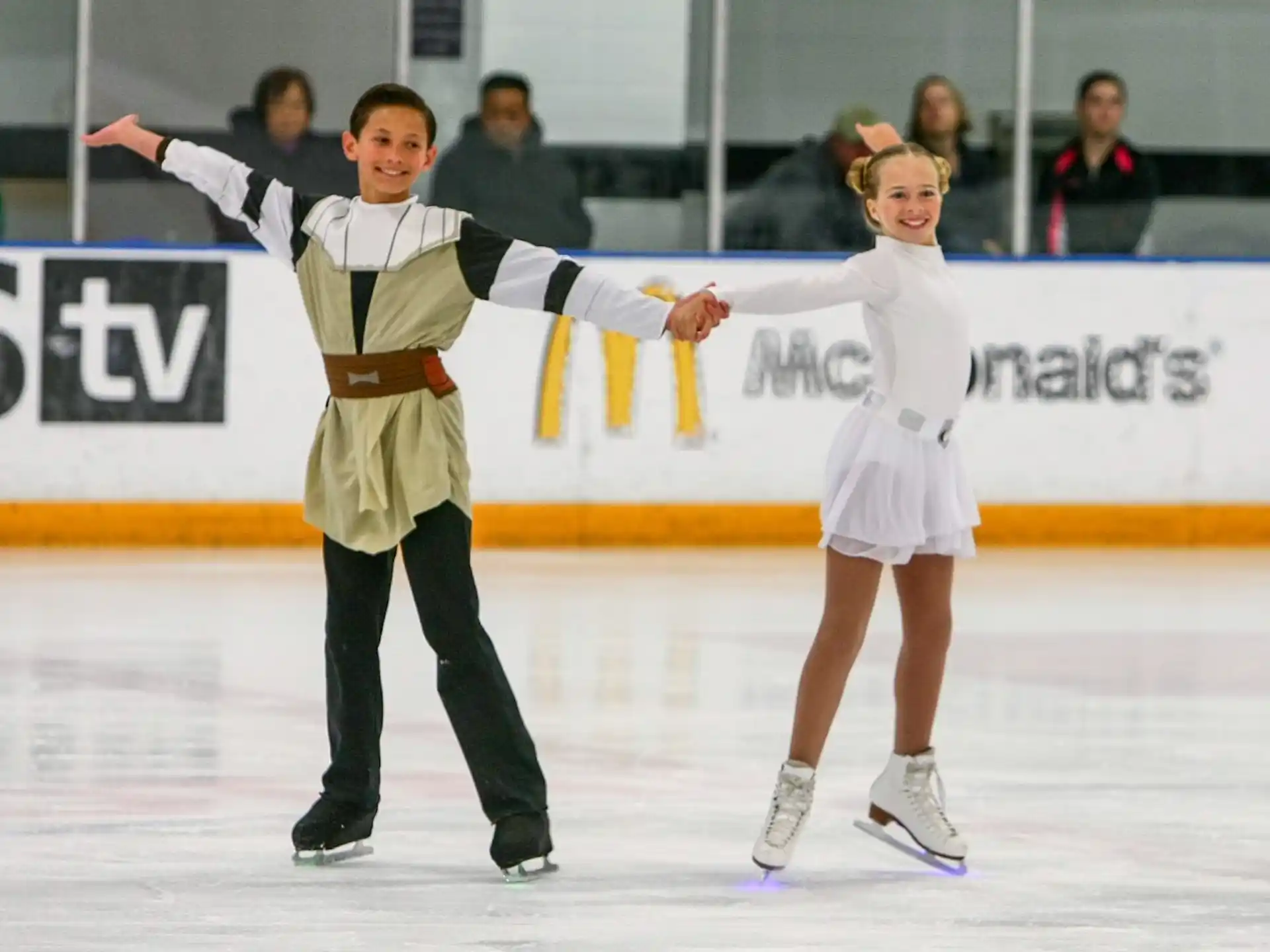 a man and woman ice skating