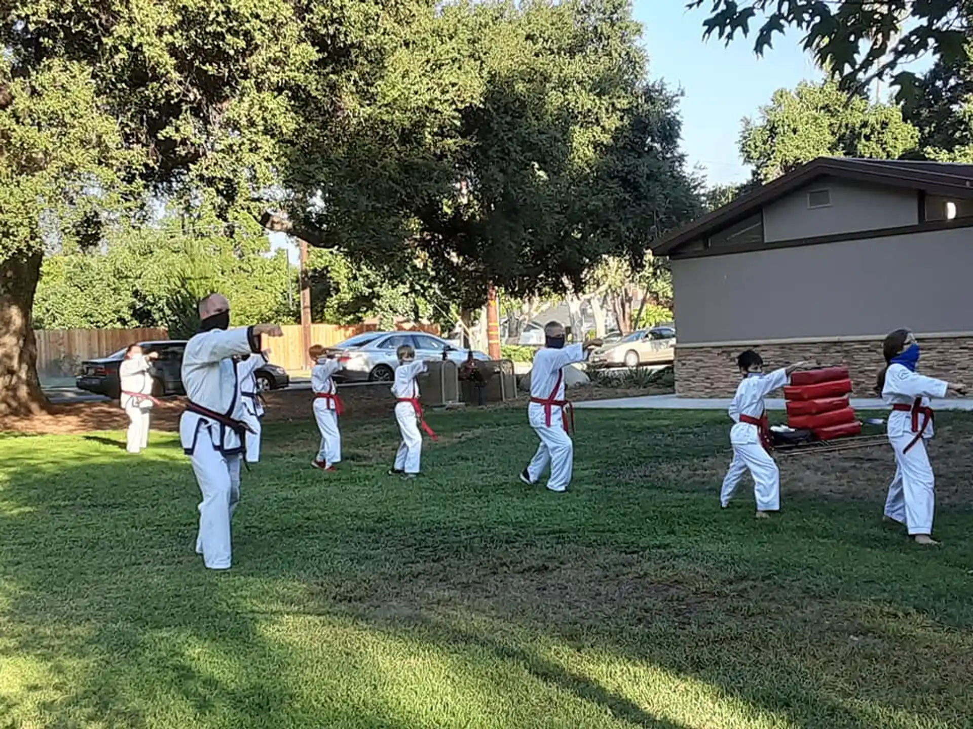 a group of people in white uniforms practicing martial arts