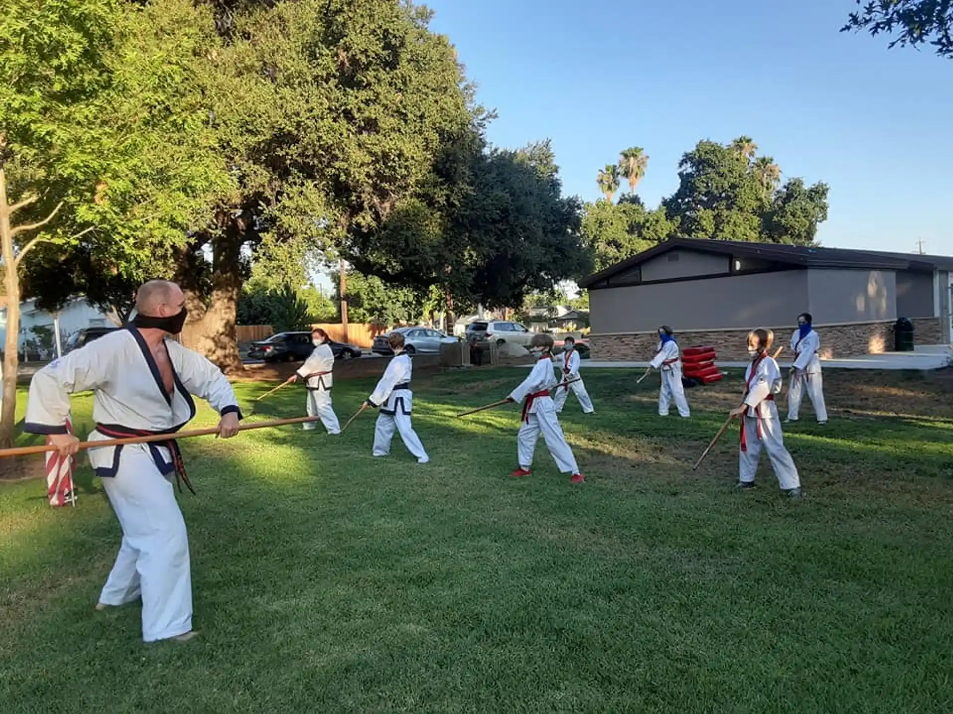 a group of people in white uniforms practicing martial arts