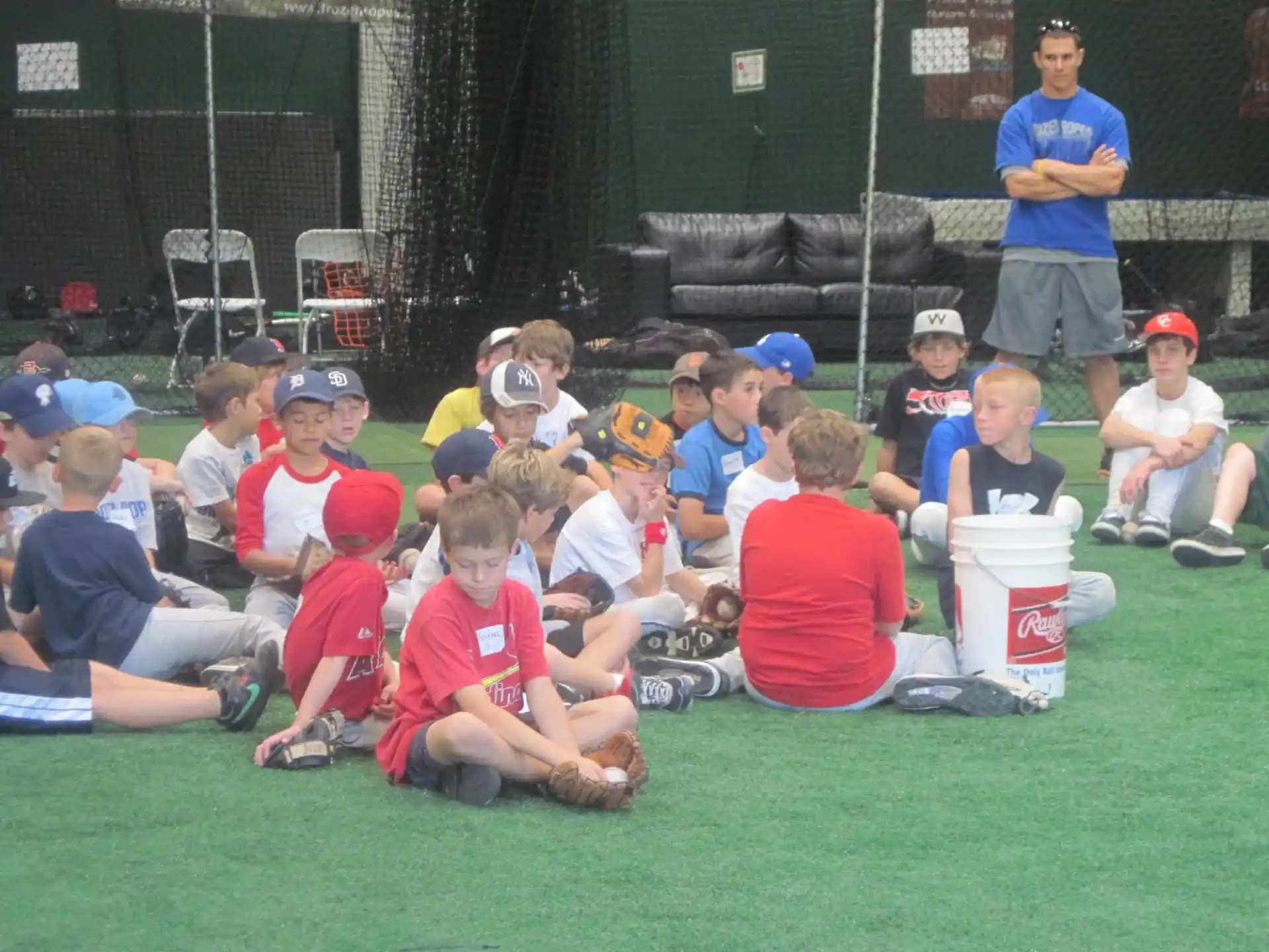 a group of kids sitting on the grass