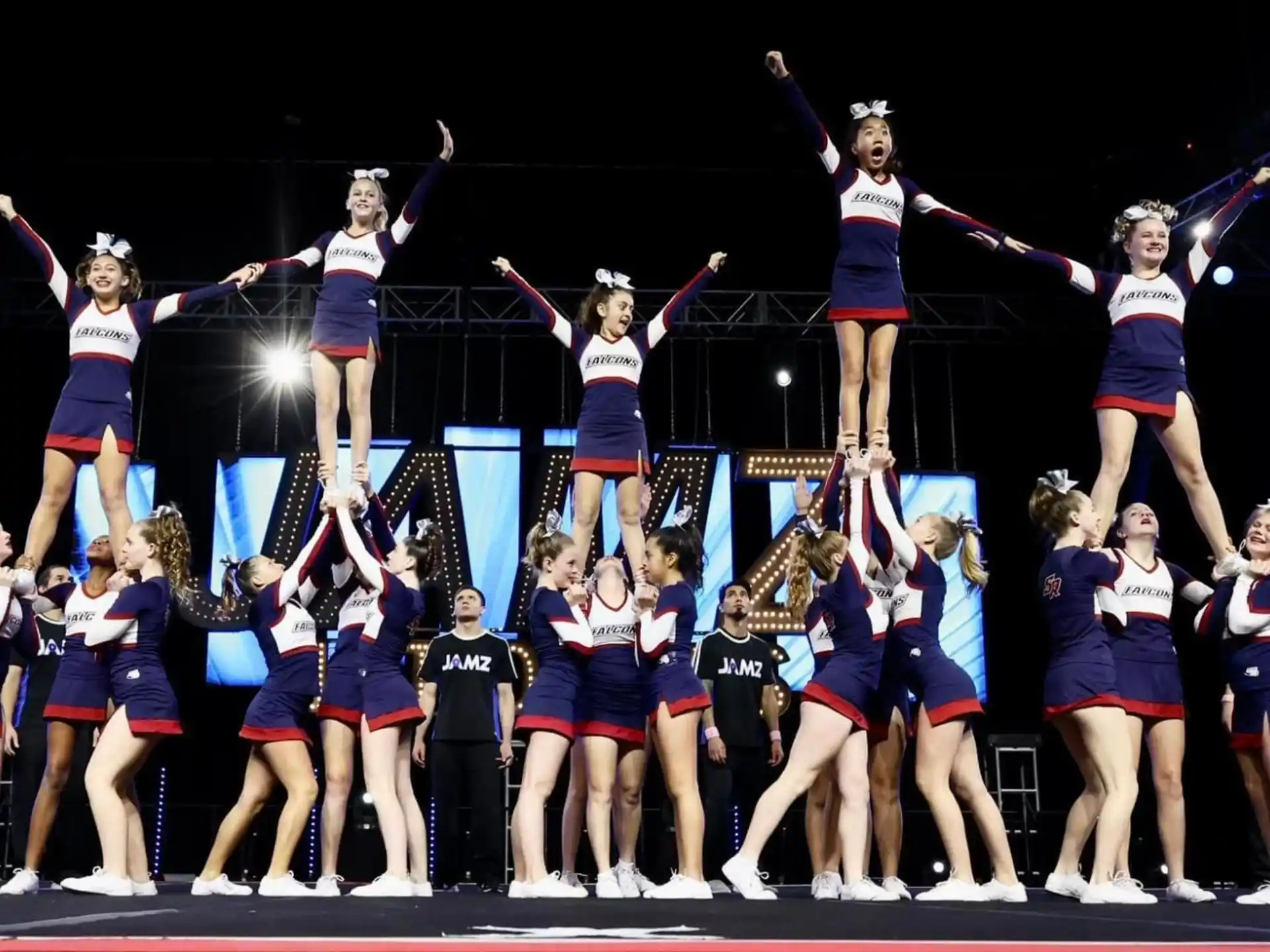 a group of cheerleaders performing on a stage