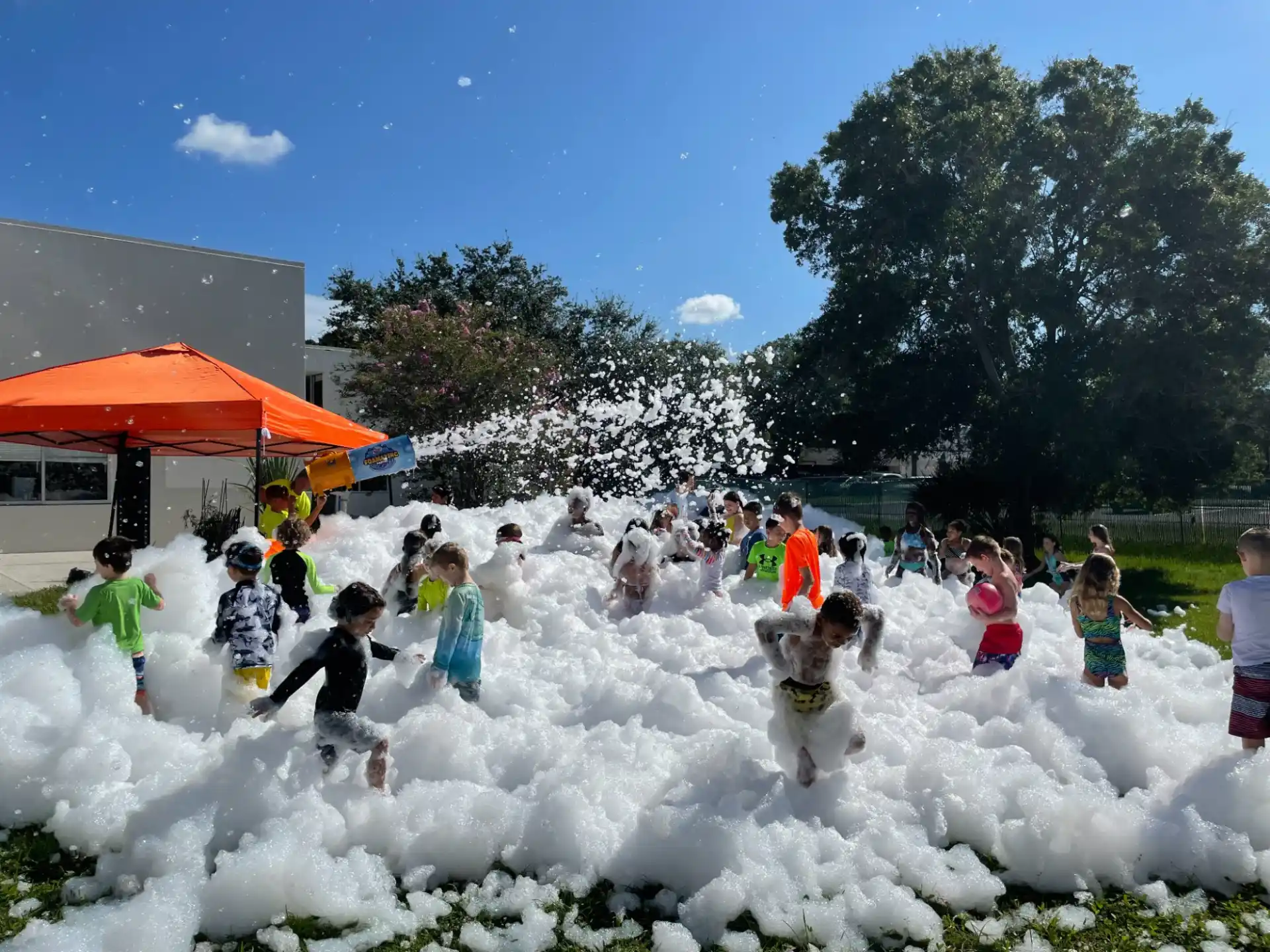a group of people playing in a field of white flowers