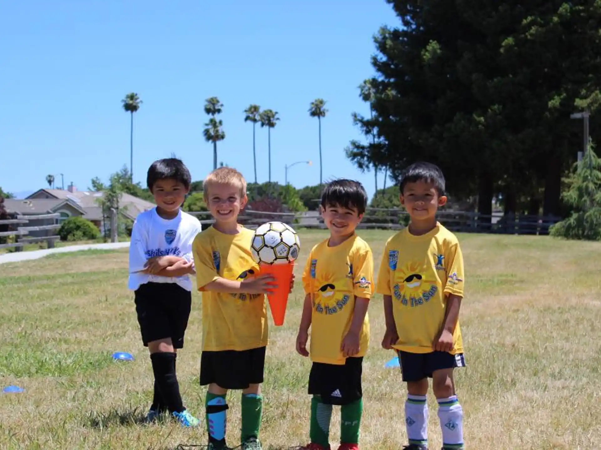 a group of boys holding a football ball