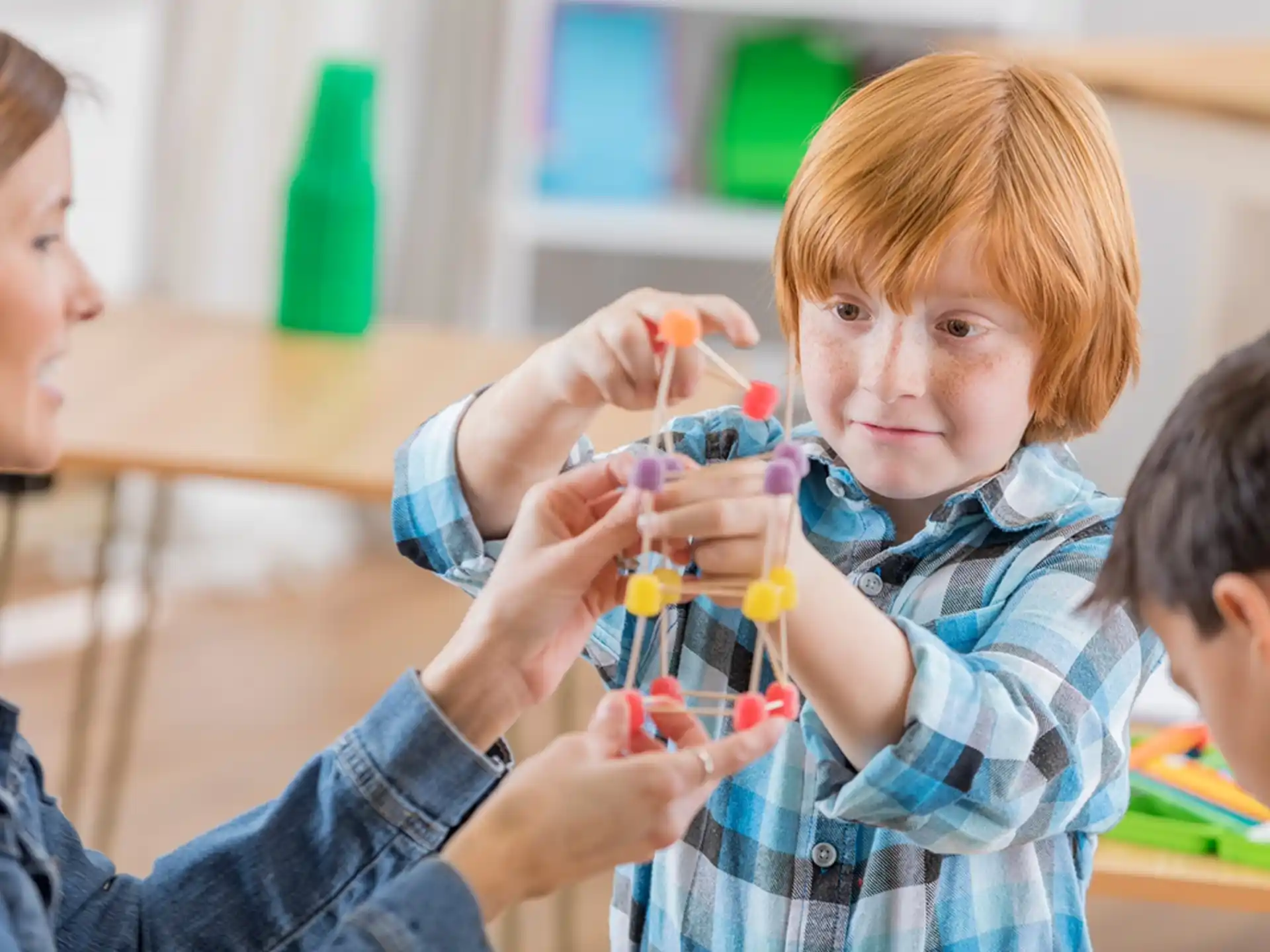 a young boy holding a toy