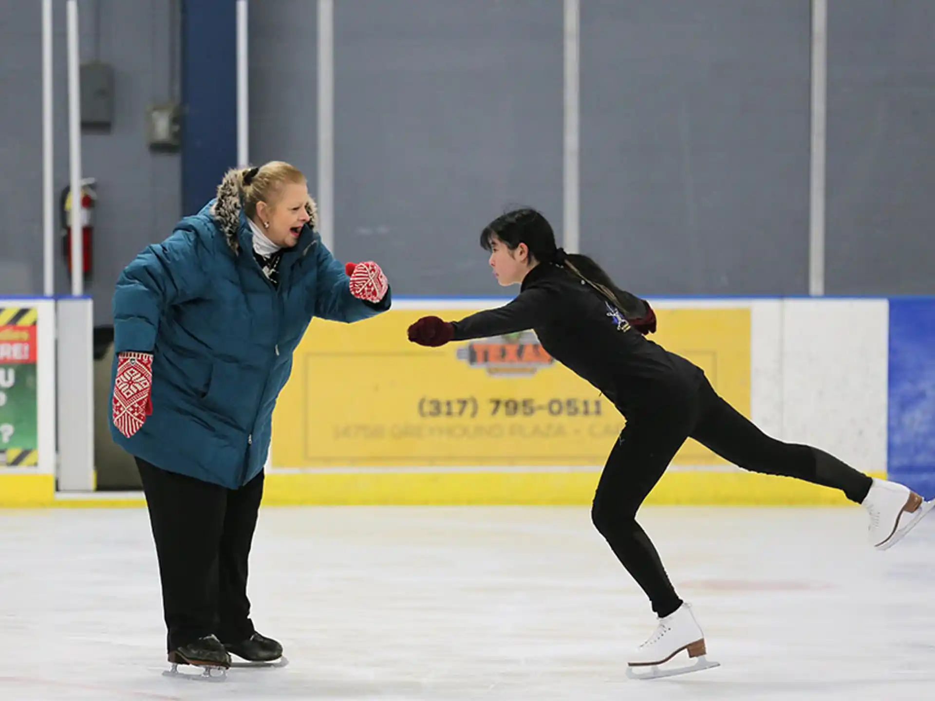 a couple of women ice skating