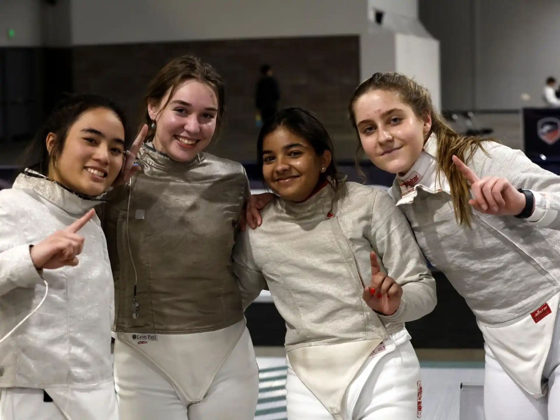 a group of women in white karate uniforms