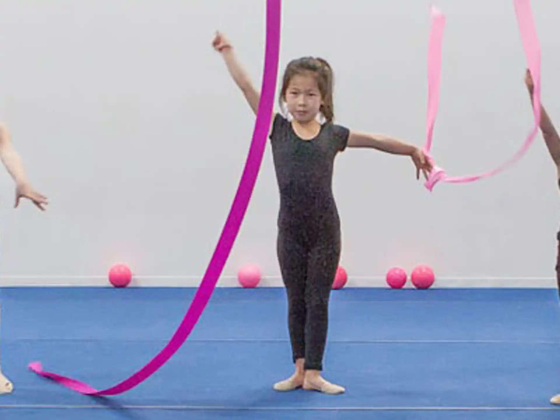 a group of girls holding a hula hoop