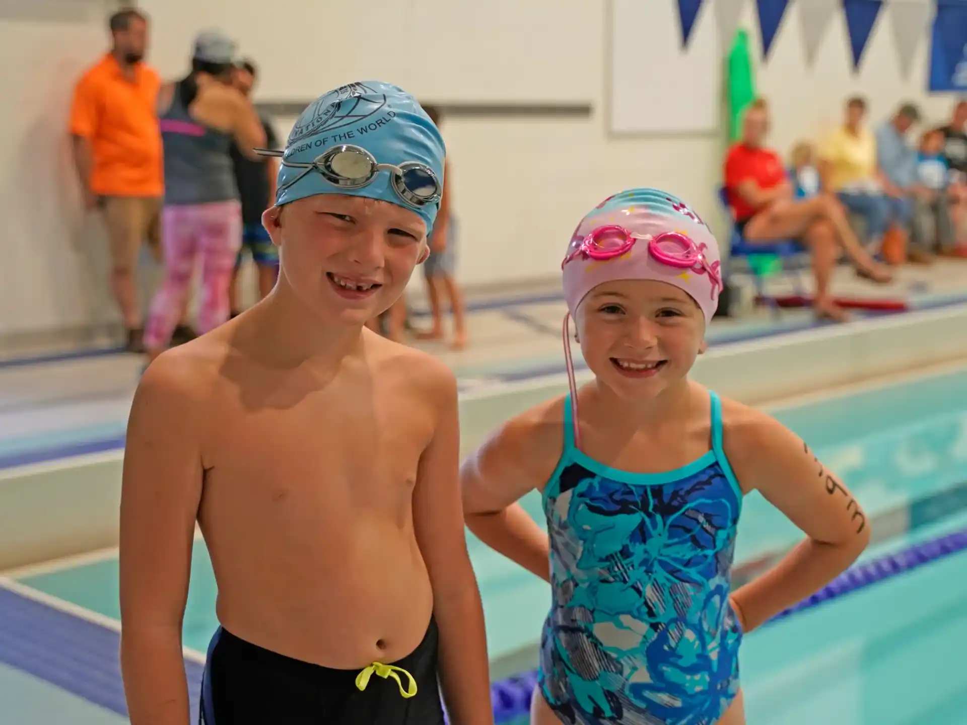 a boy and girl in swim gear