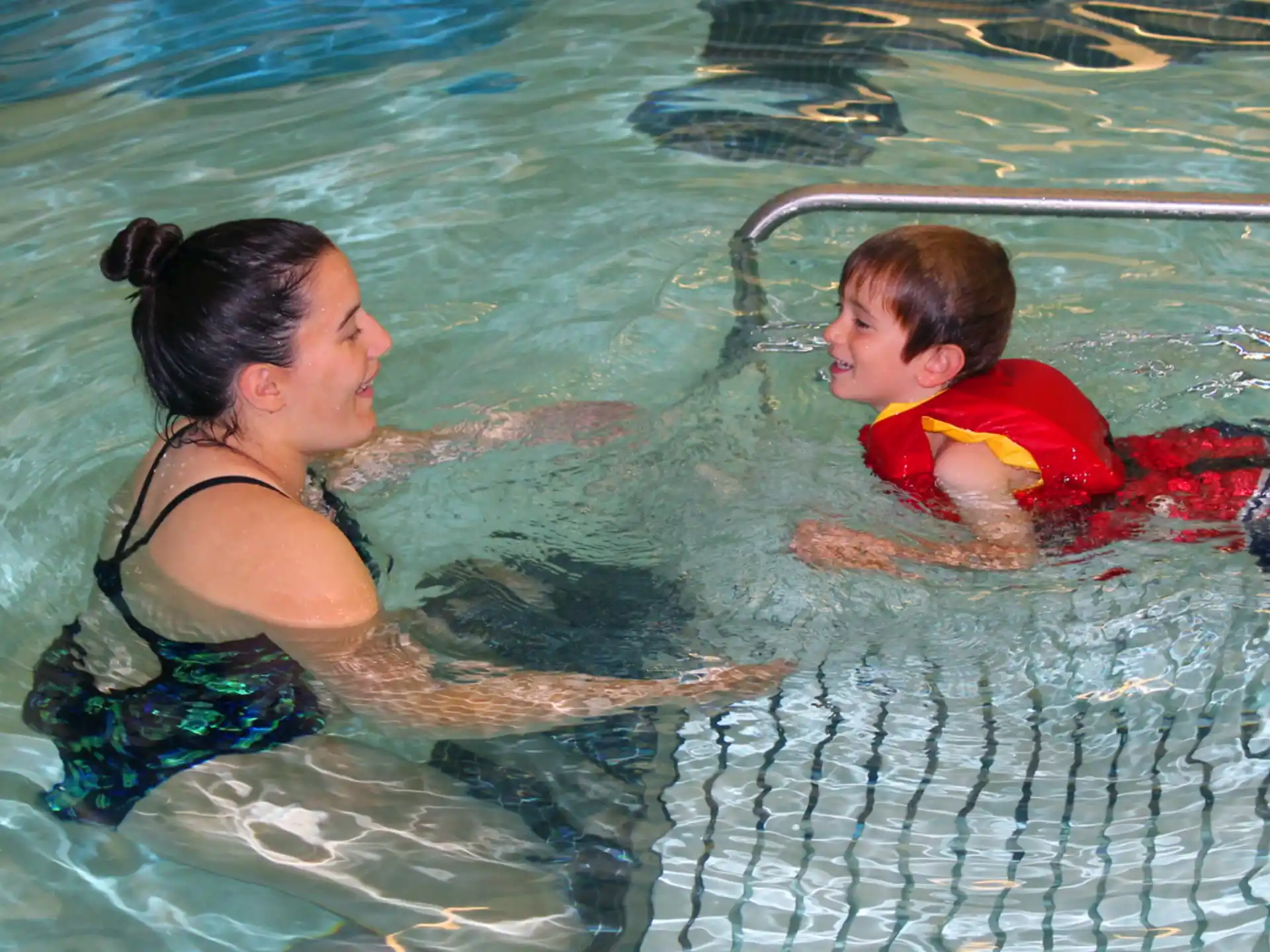 a man and a boy in a pool