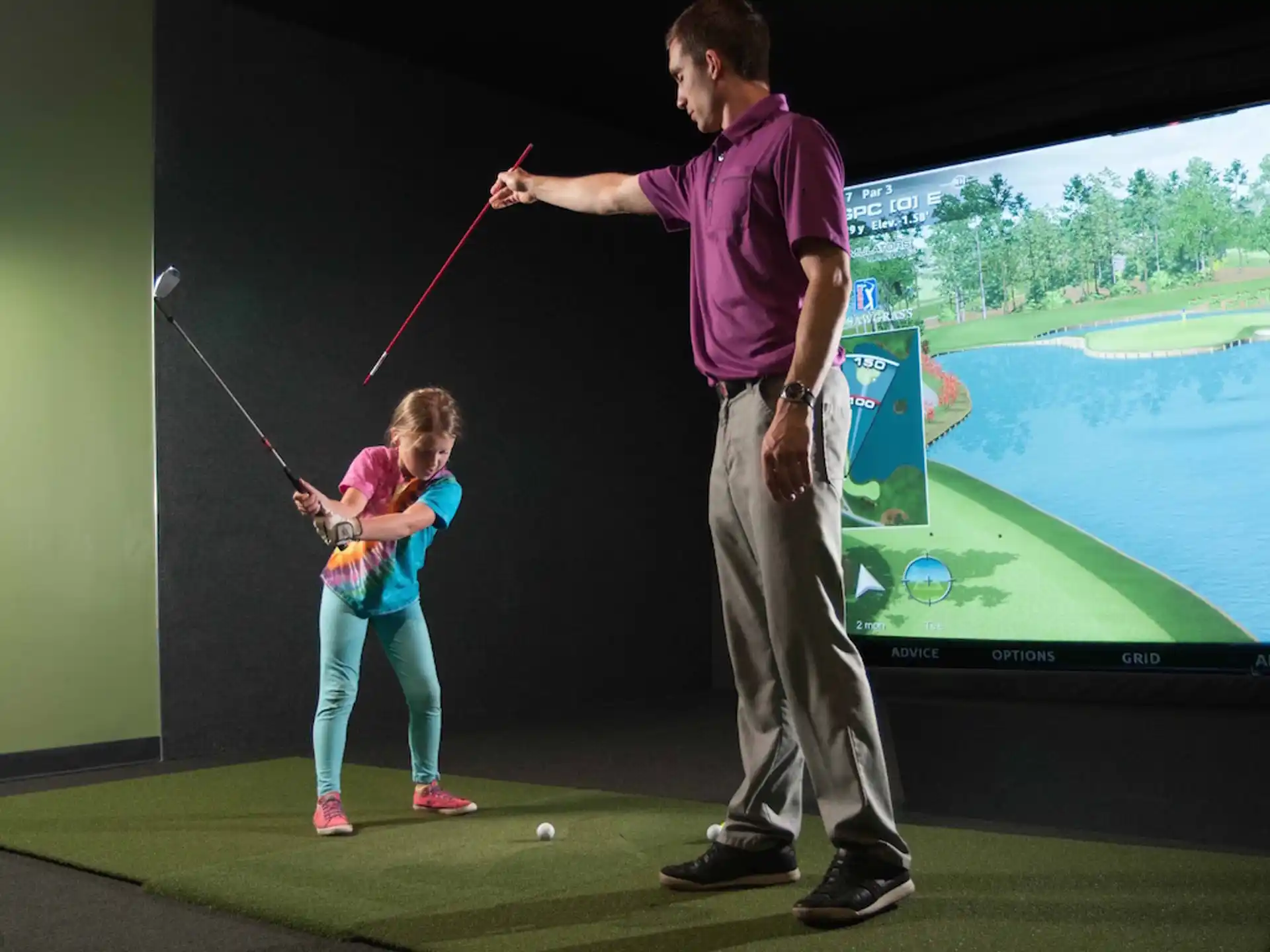 a man and a girl playing golf