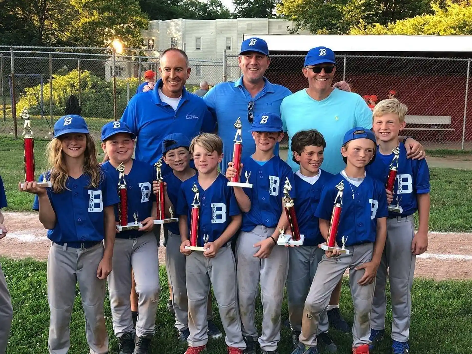 a group of people wearing matching blue shirts and standing on a field
