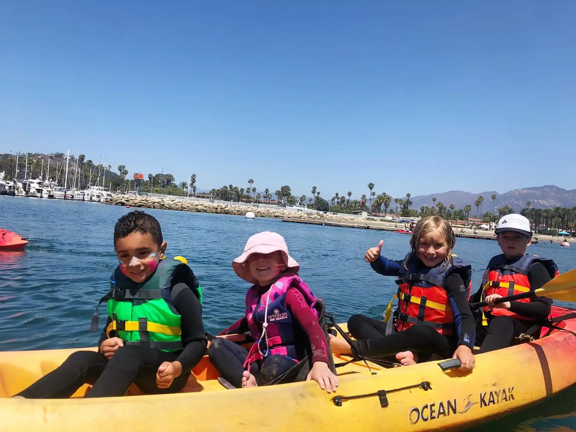 a group of kids in a canoe