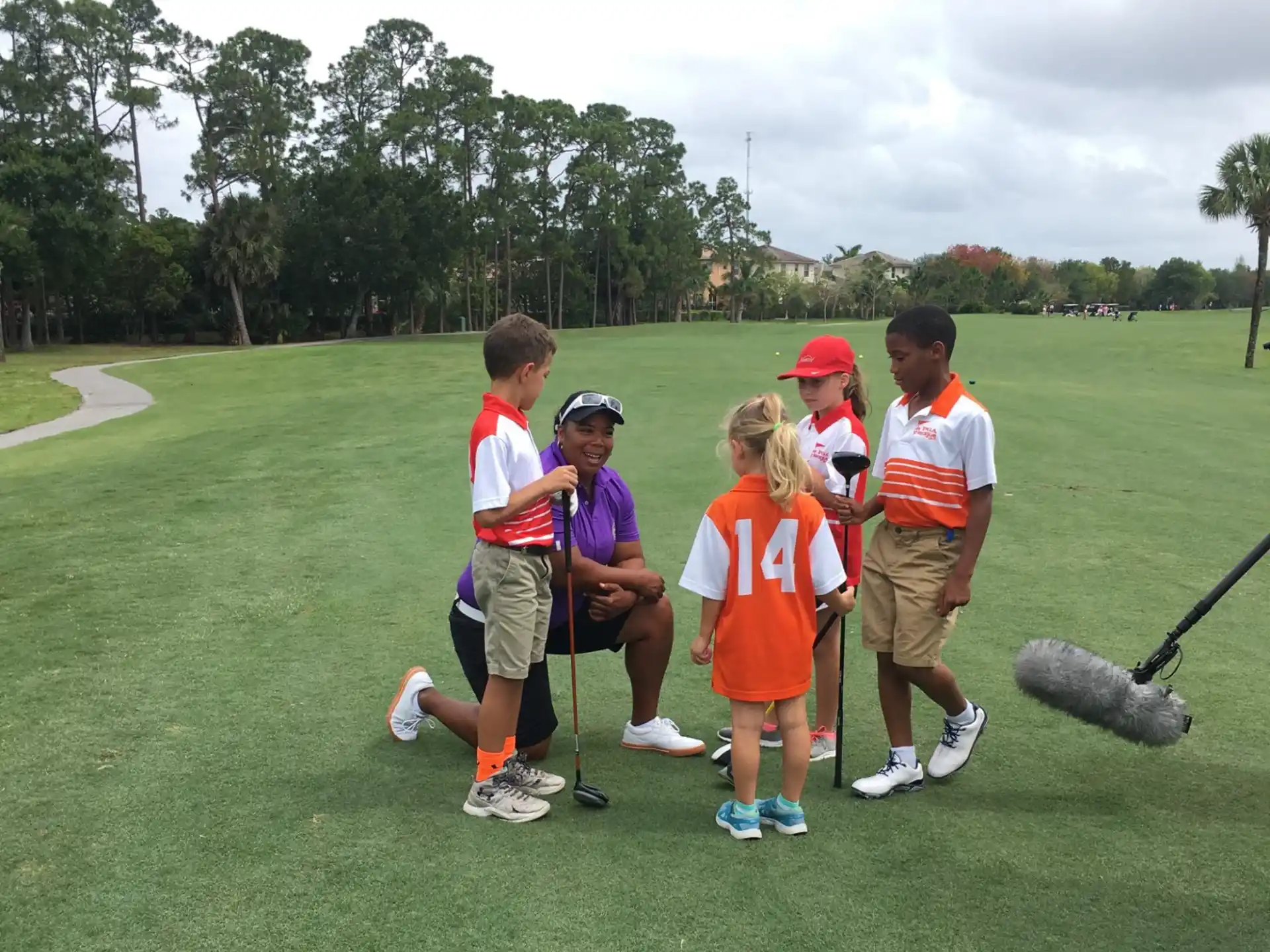 a group of people standing on a golf course