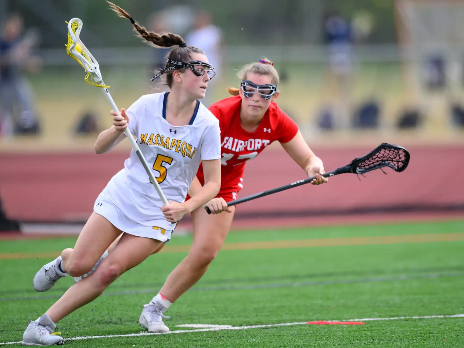 women playing lacrosse on a field