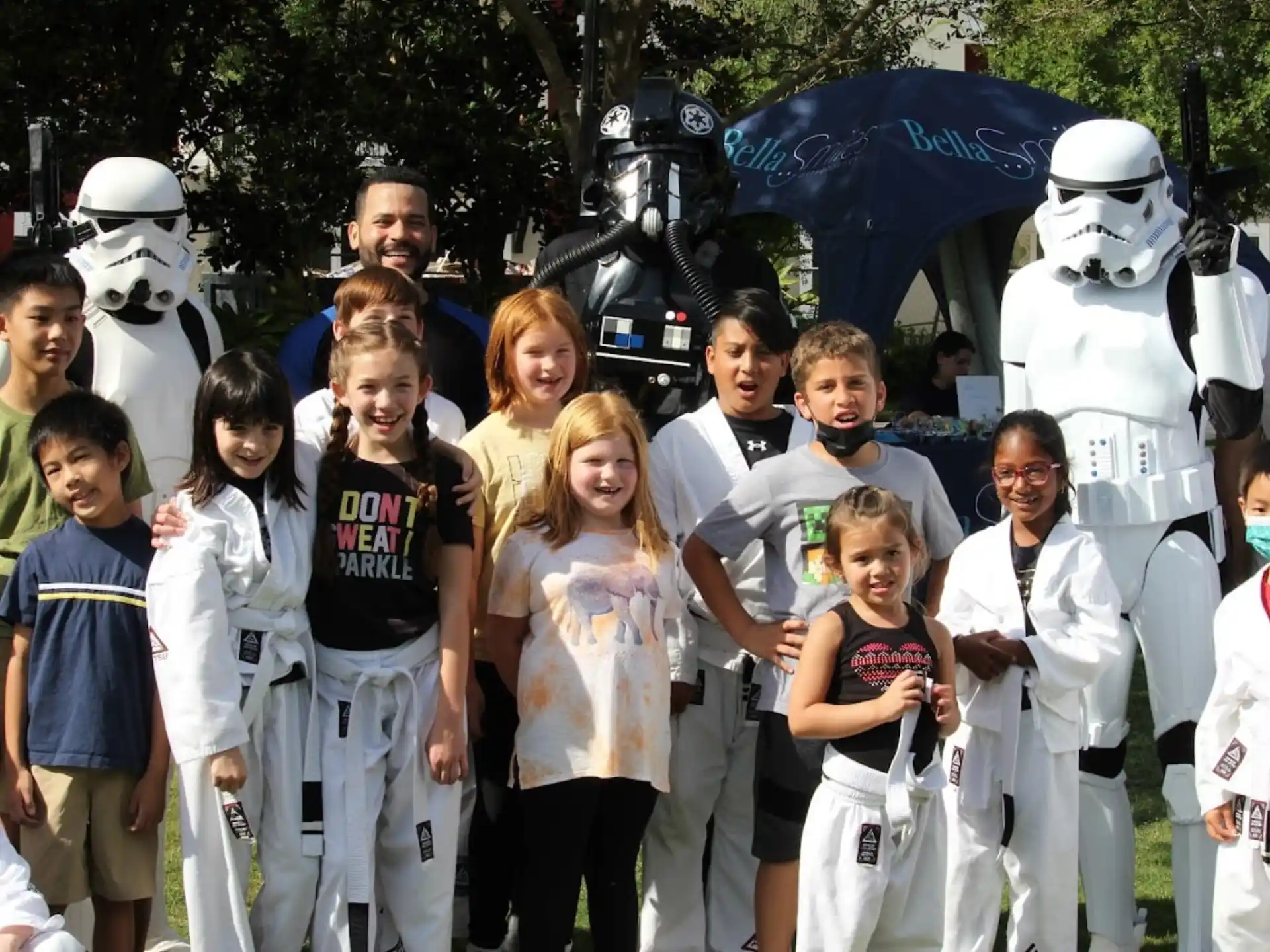 a group of people posing for a photo with people in clothing