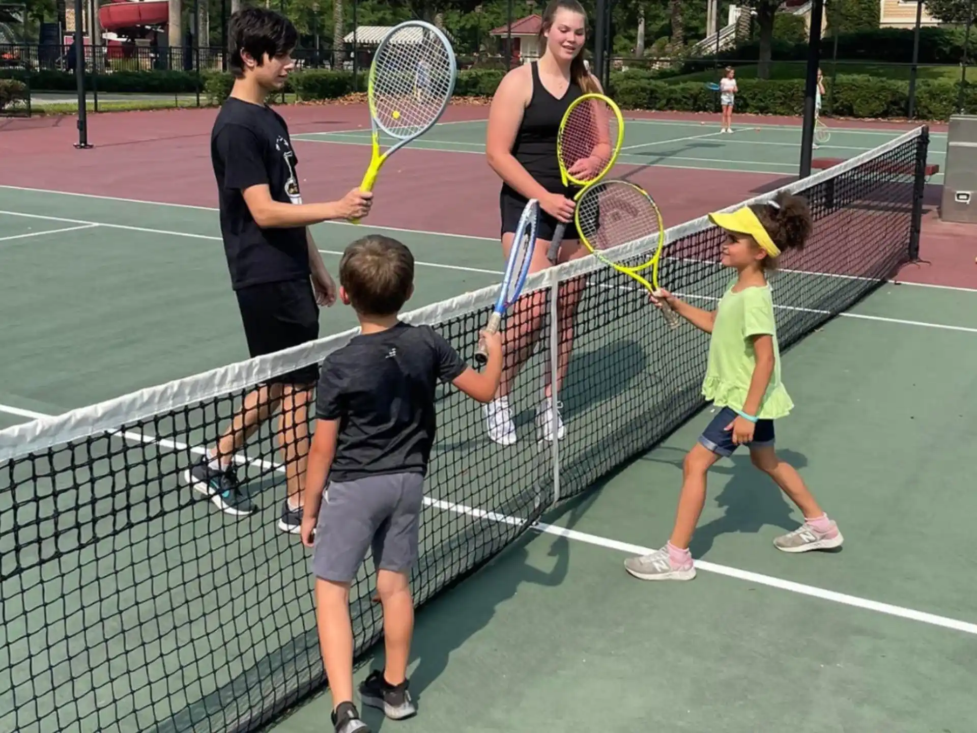 a group of people playing tennis