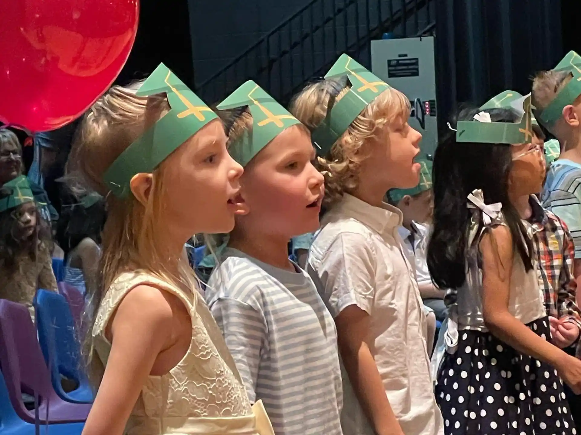 a group of children wearing party hats