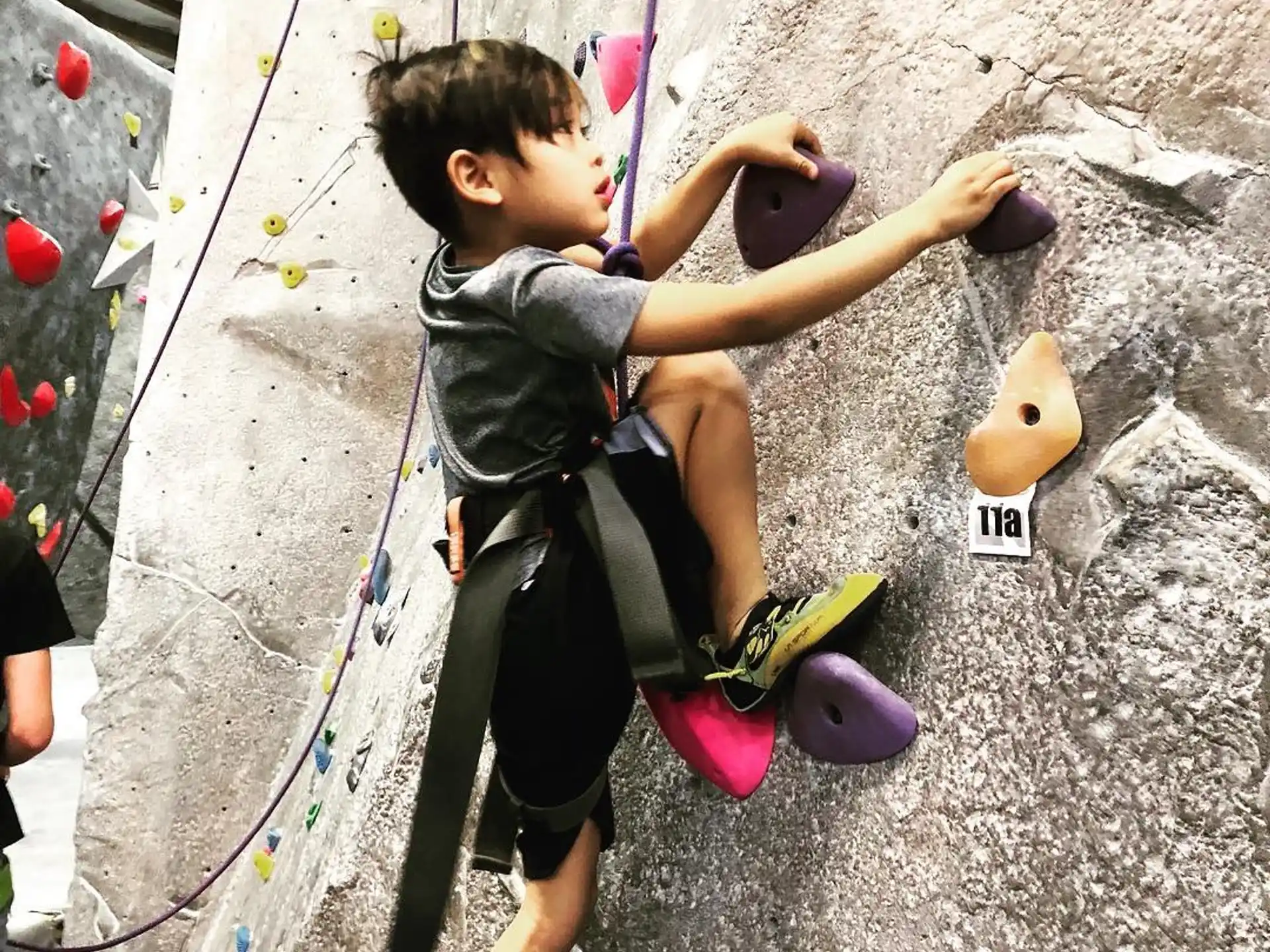 a boy climbing a rock wall
