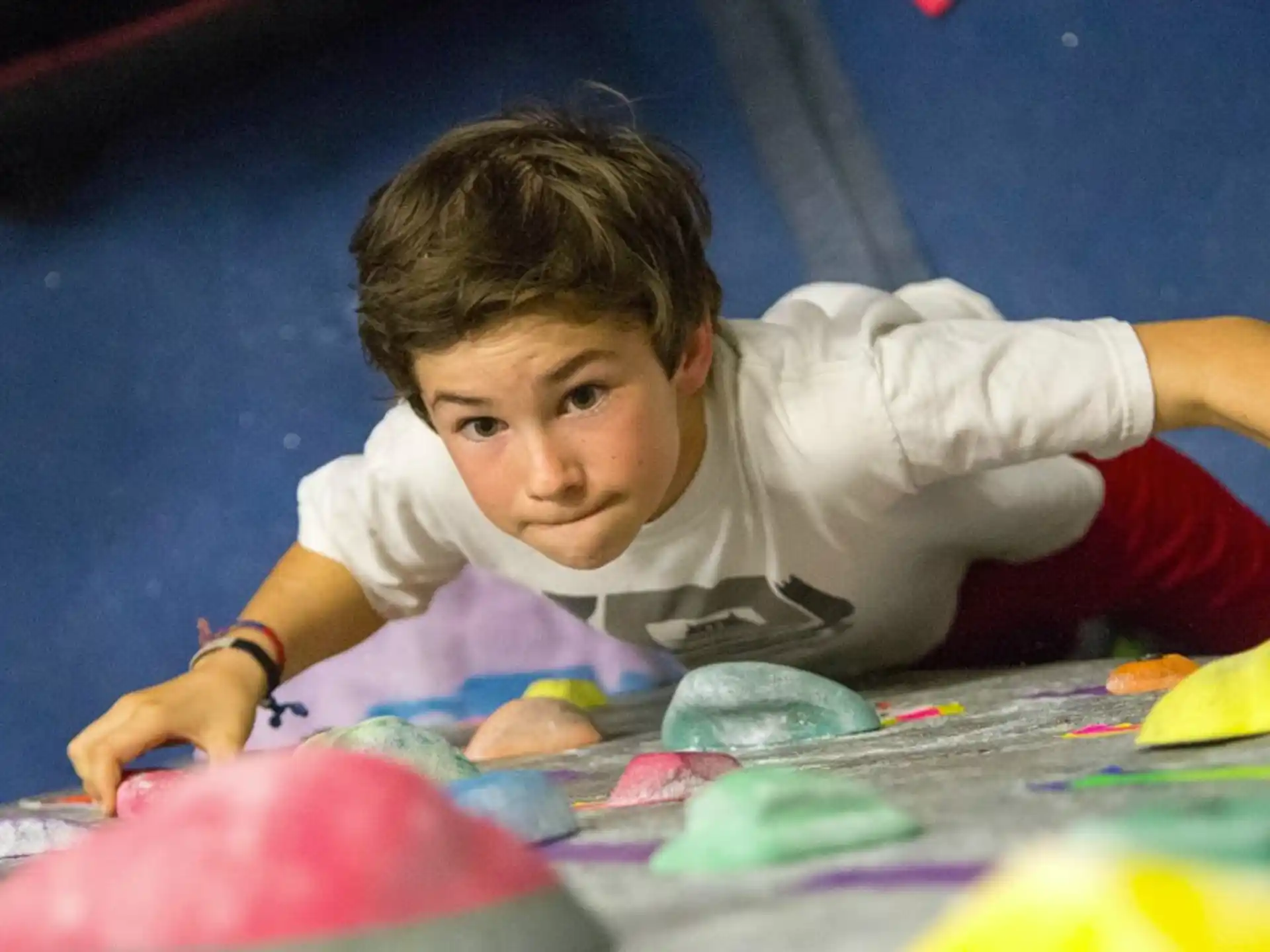 a boy lying on a colorful floor
