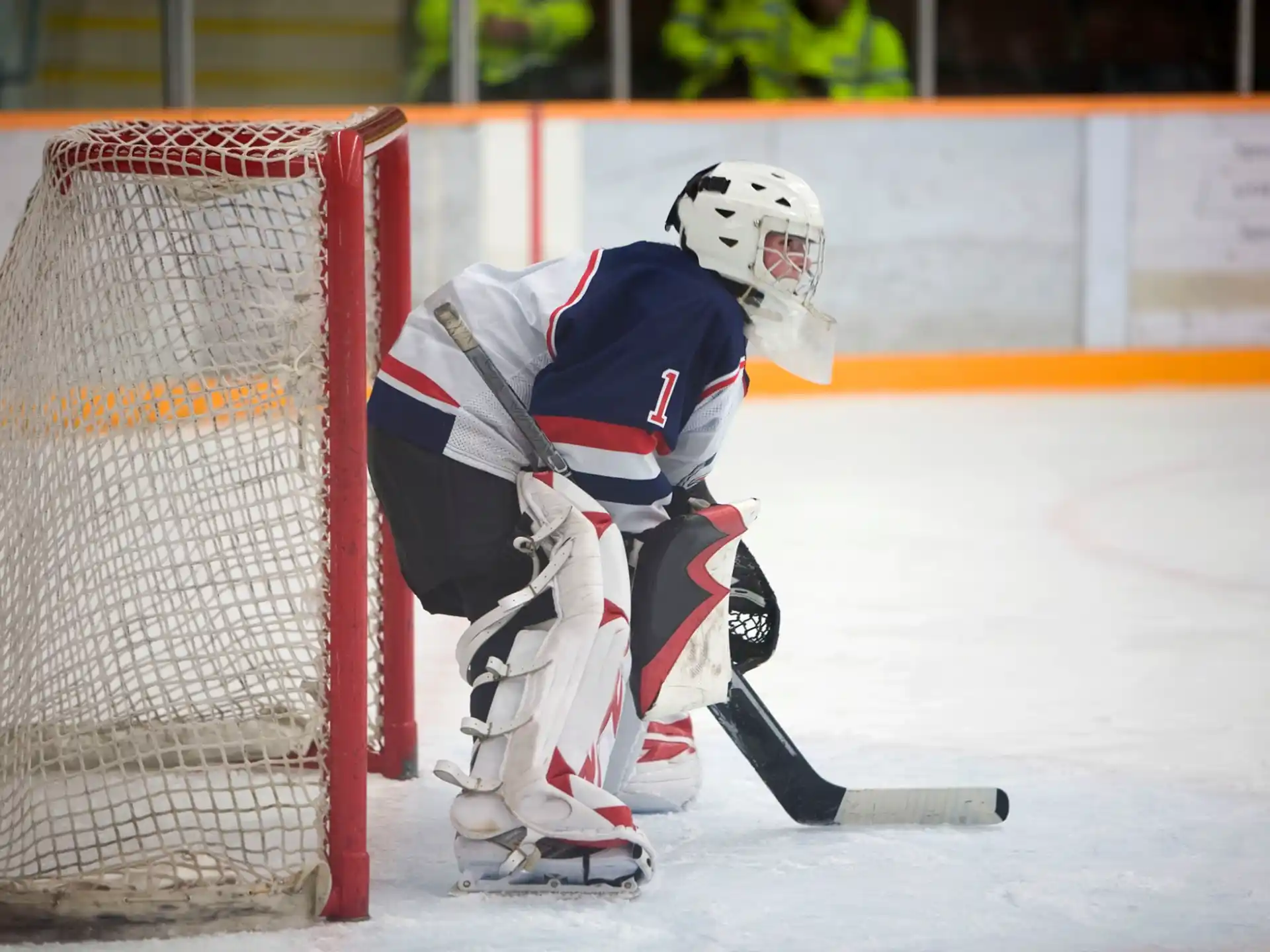 a hockey player in a white uniform
