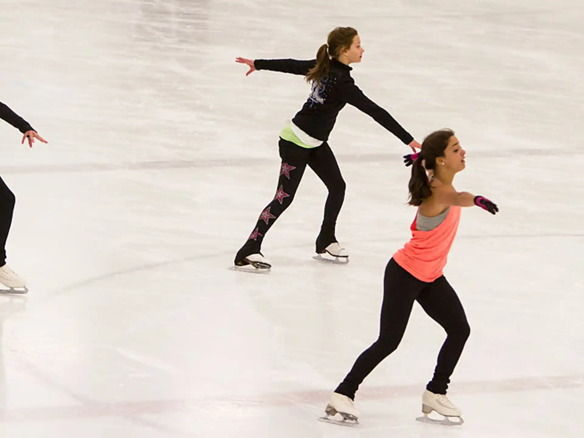 a group of women ice skating