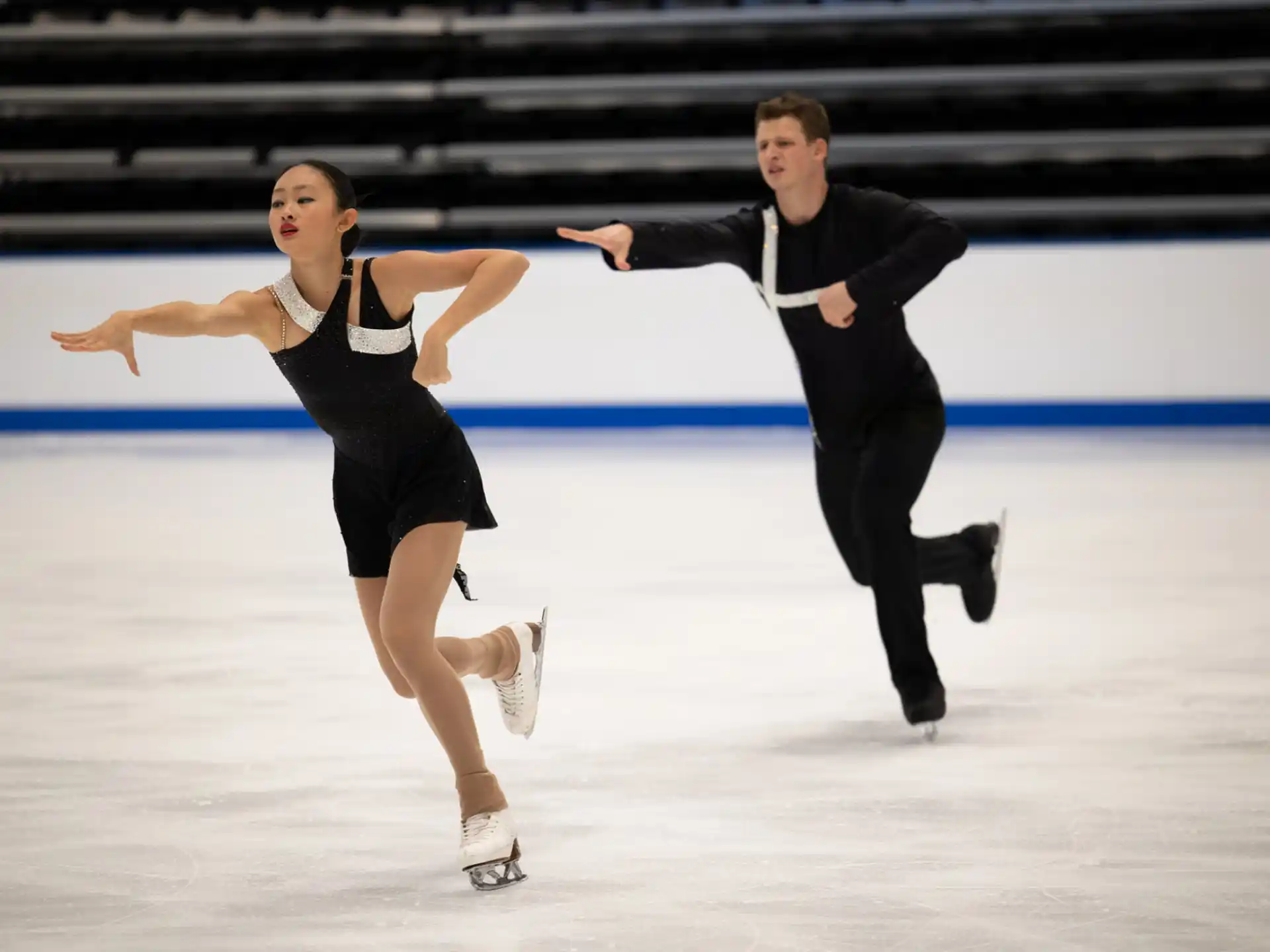 a man and woman ice skating