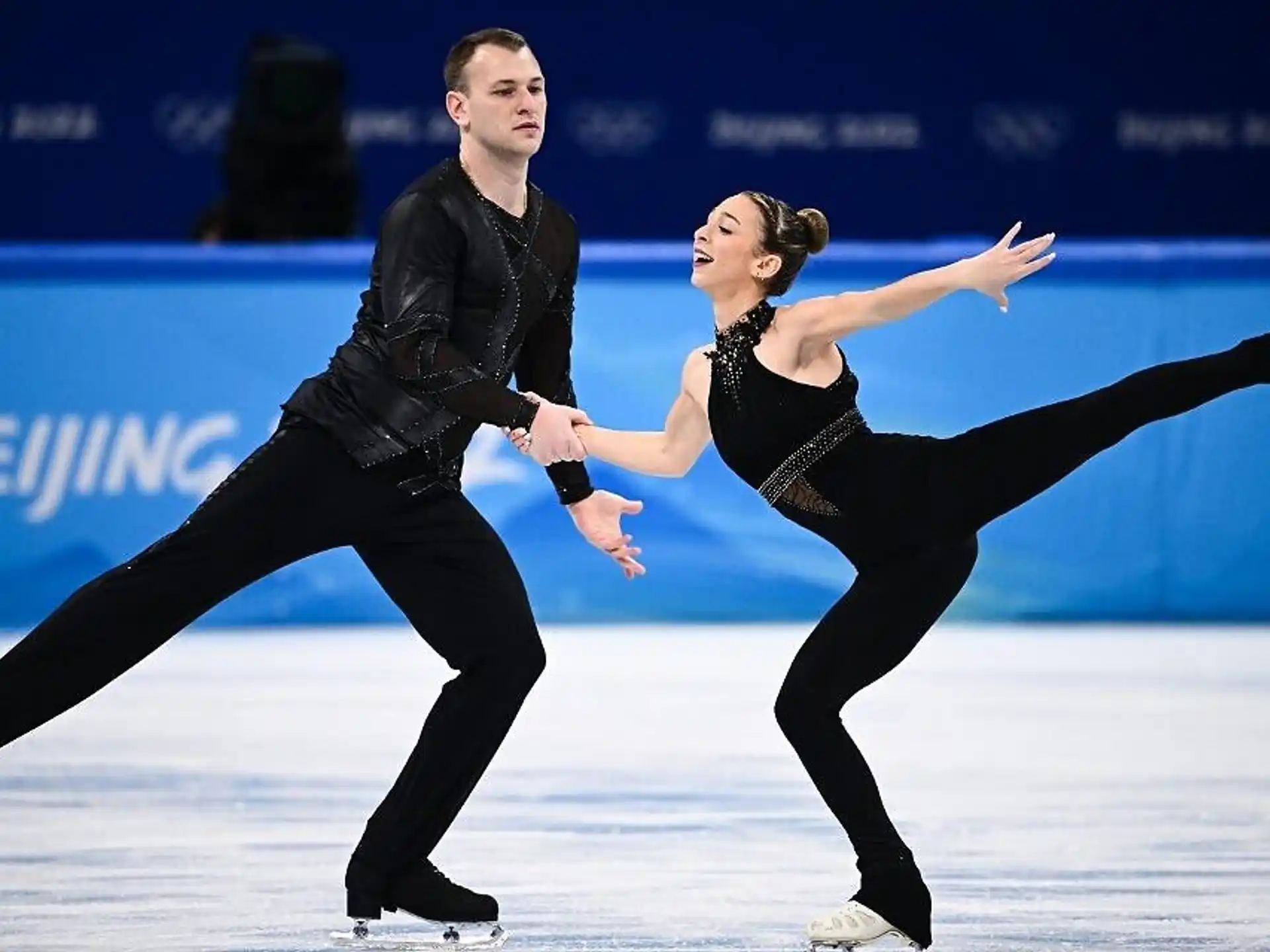 a man and woman ice skating