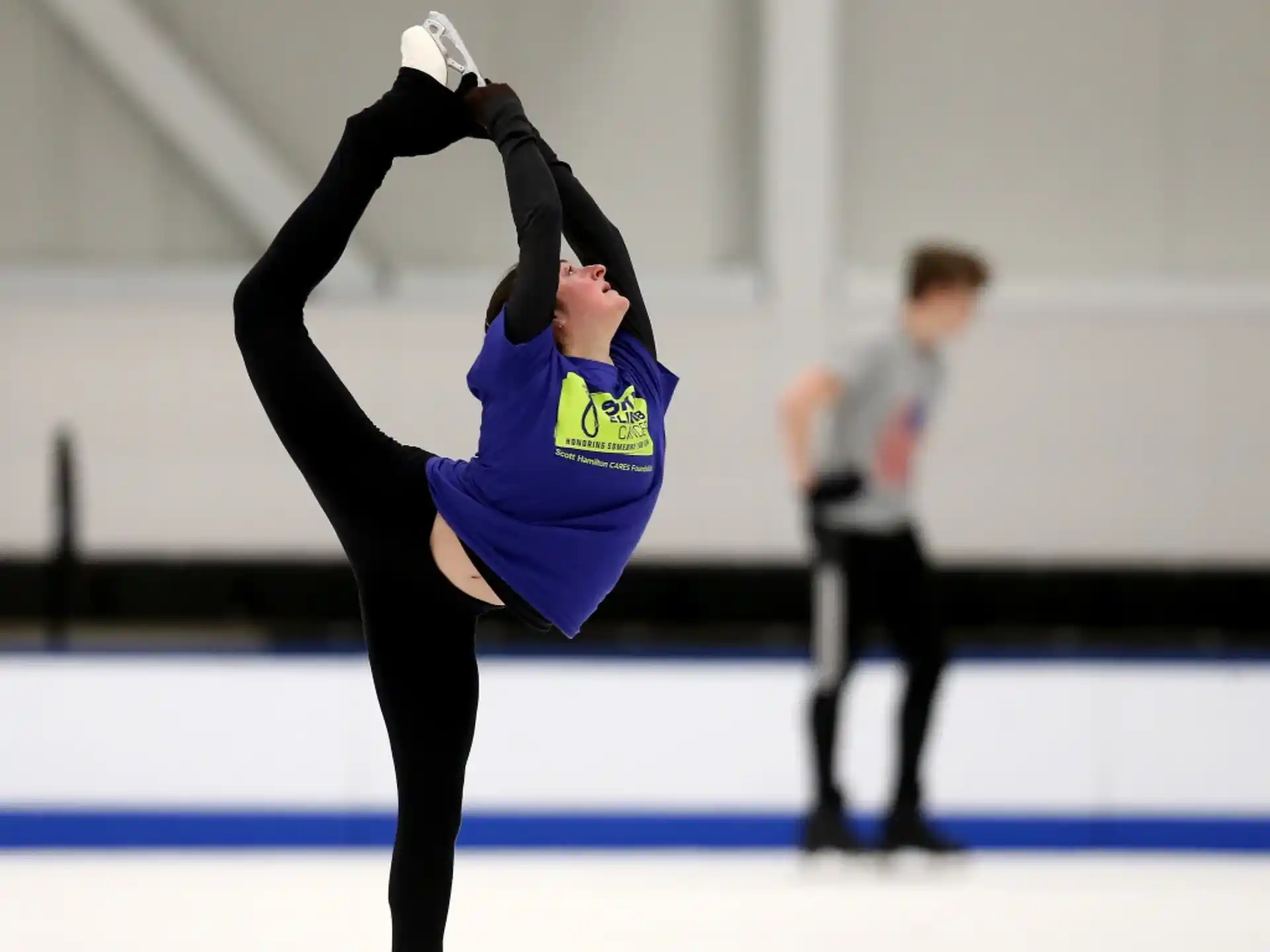 a woman doing a handstand on ice