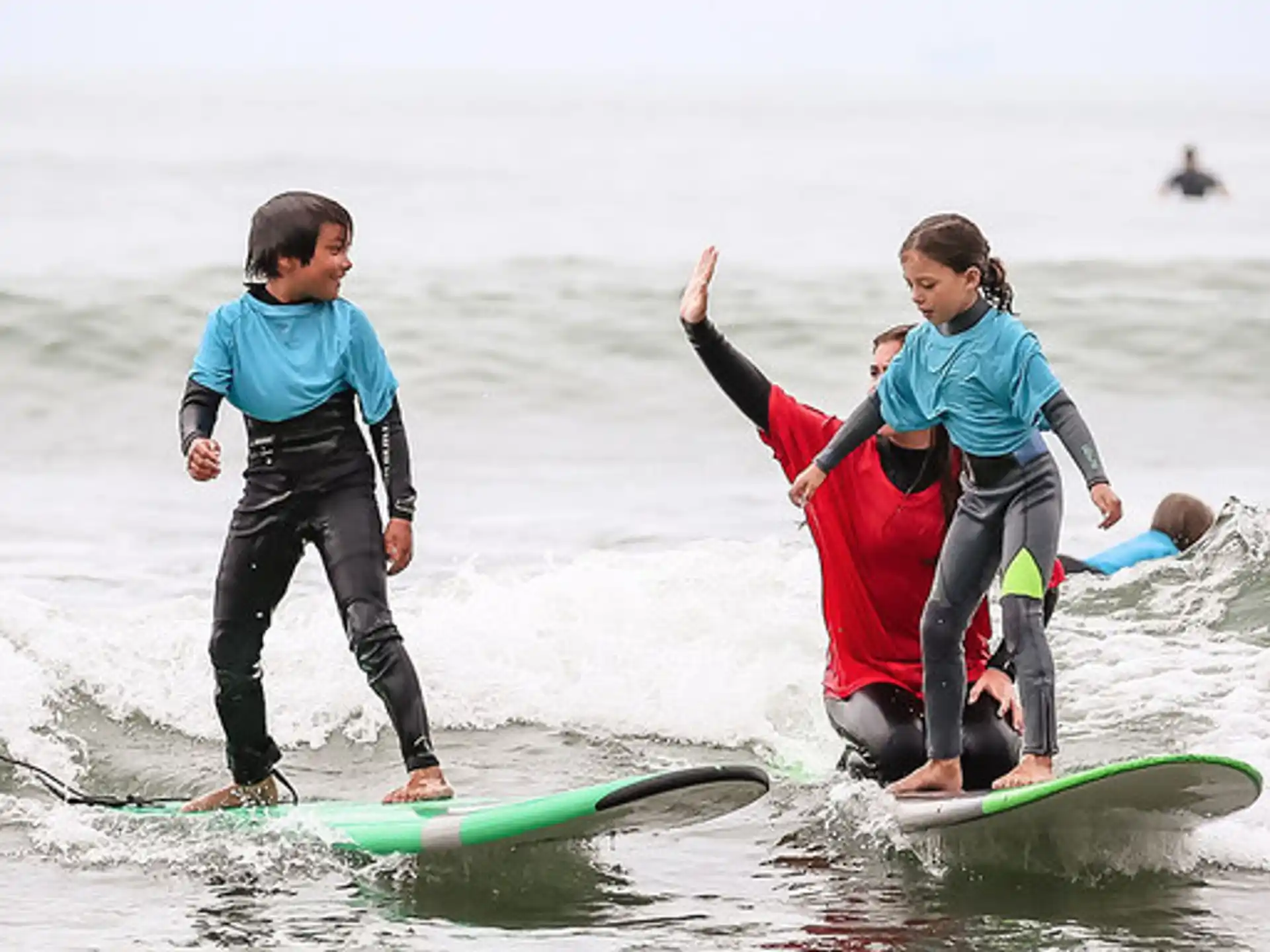 a group of people surfing in the sea