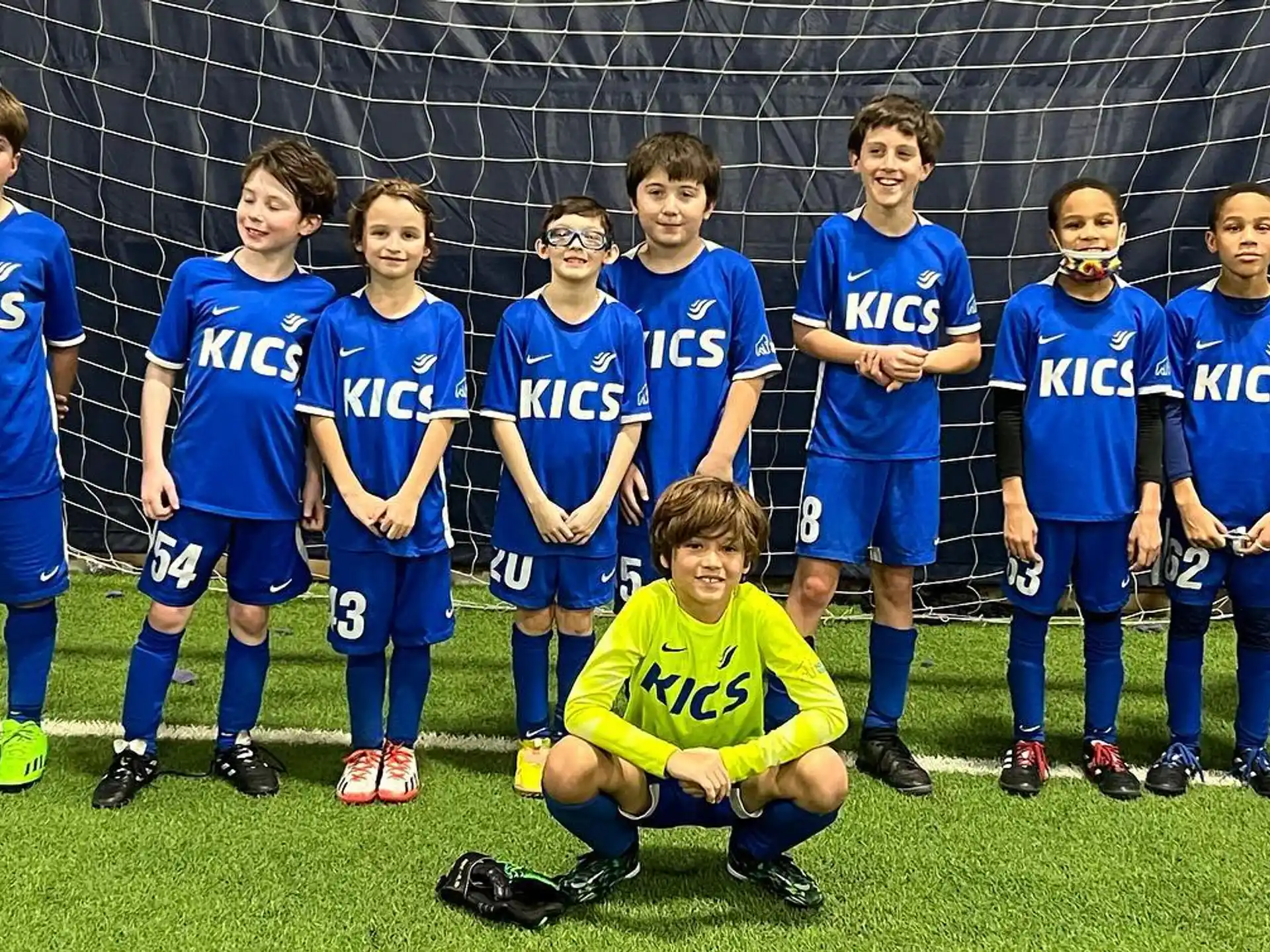a group of kids in football uniforms
